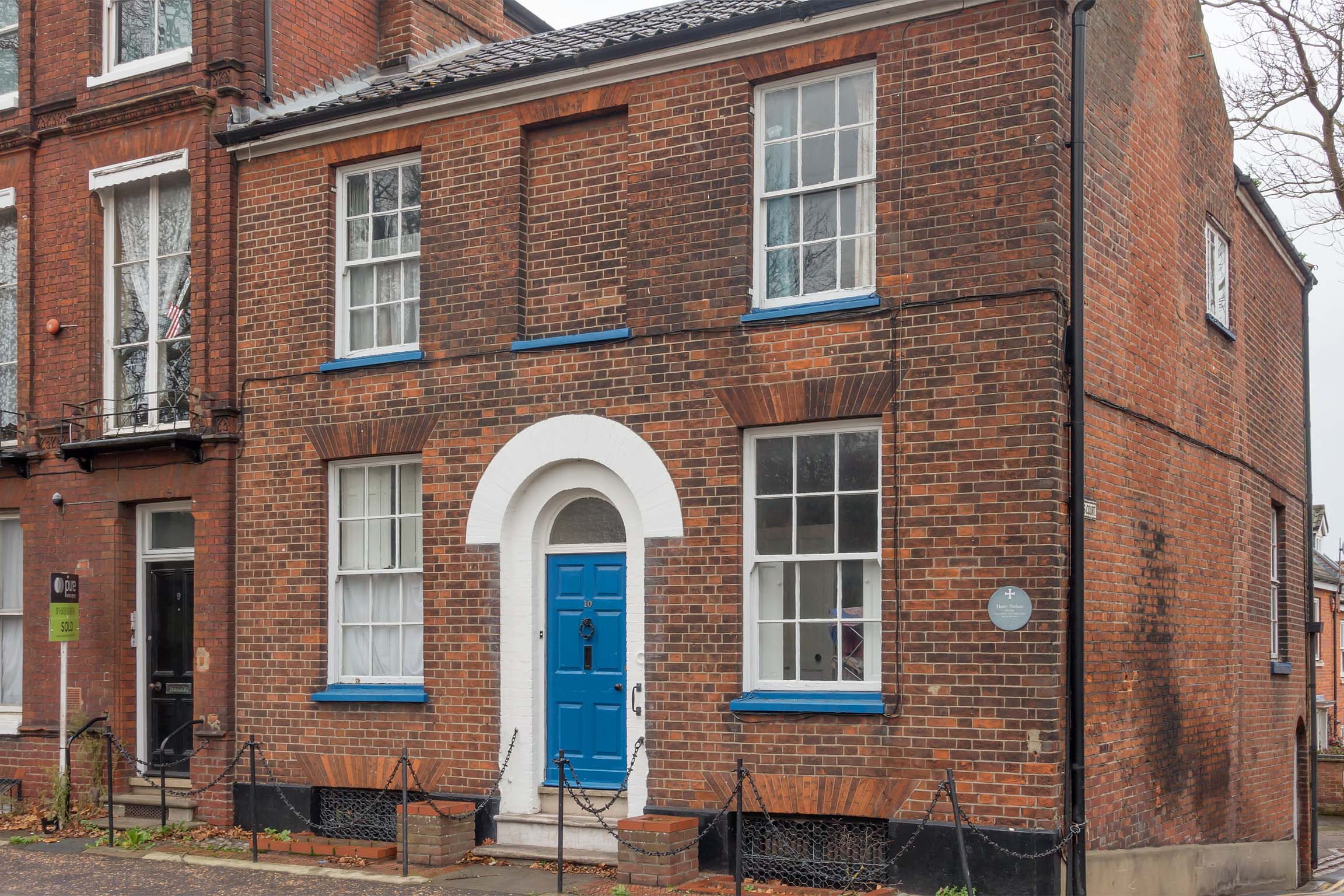Brick building with blue front door