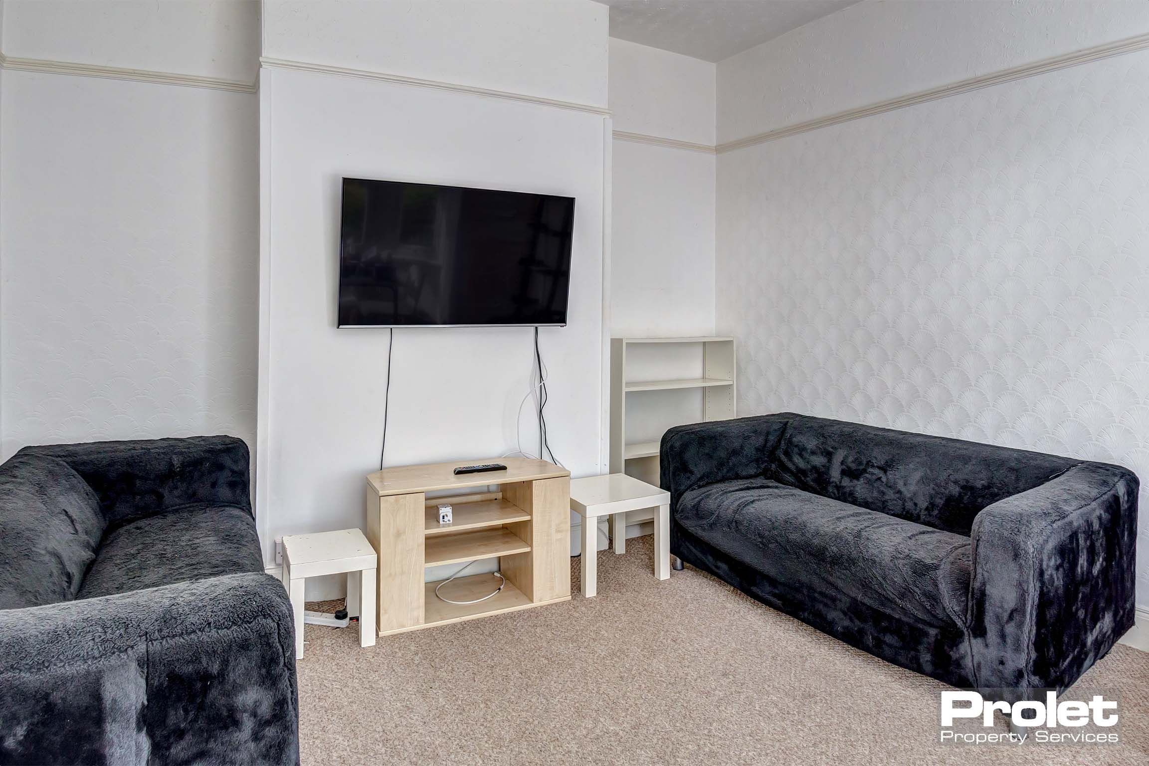 Living room with black leather effect sofas