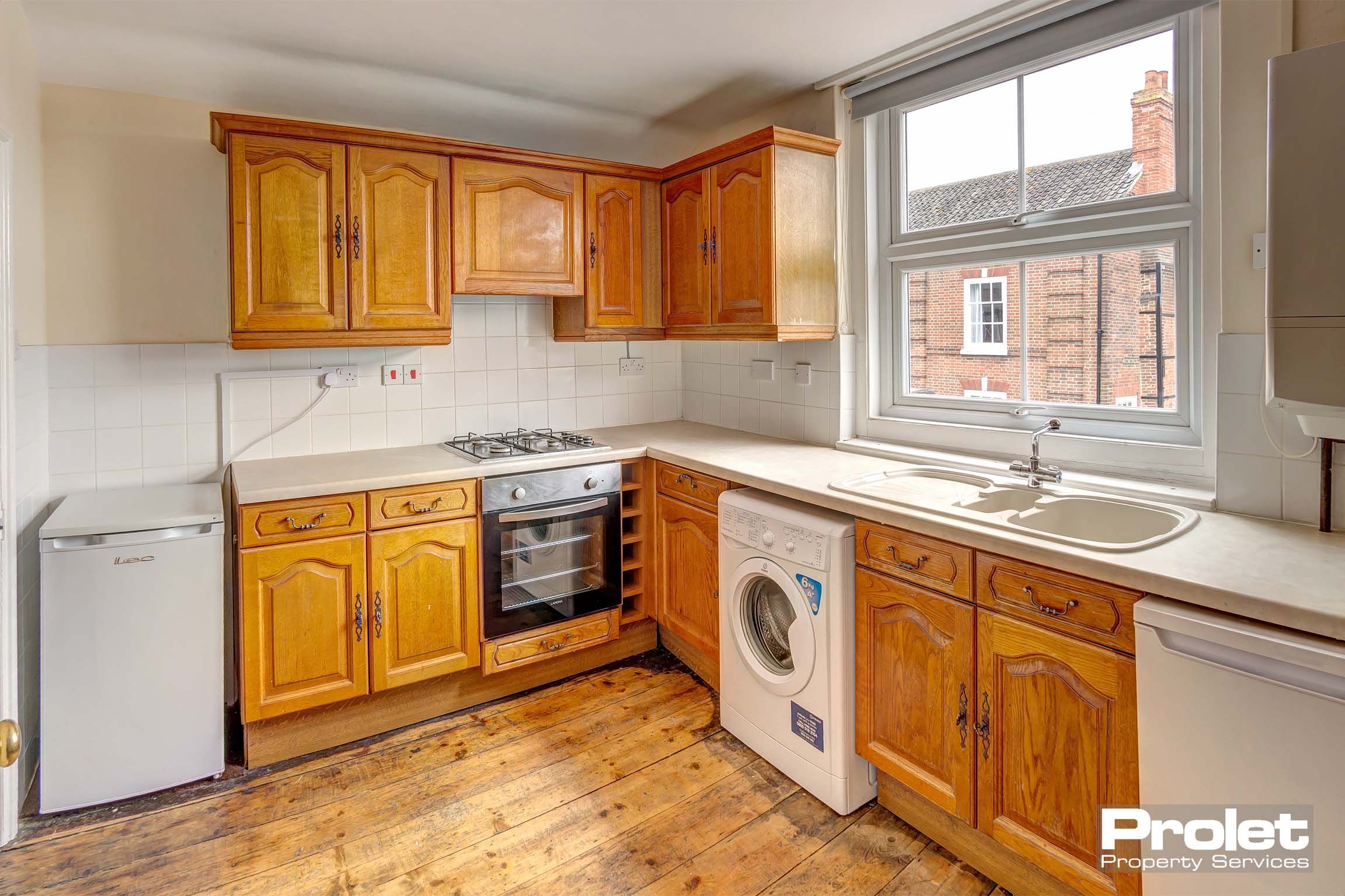 Wooden fitted kitchen, with wooden flooring.