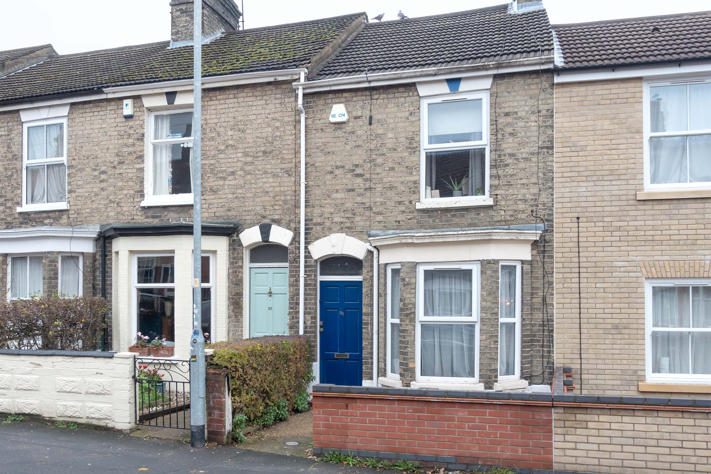 Brick terraced house with dark blue door