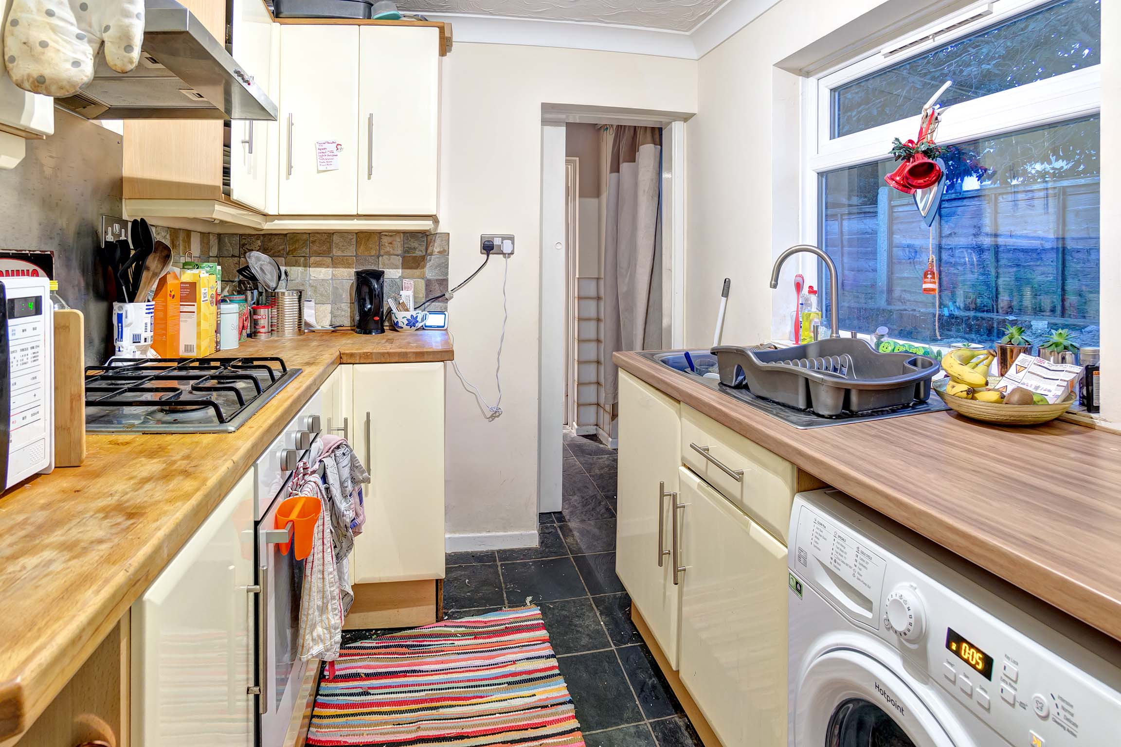 Galley kitchen with white goods