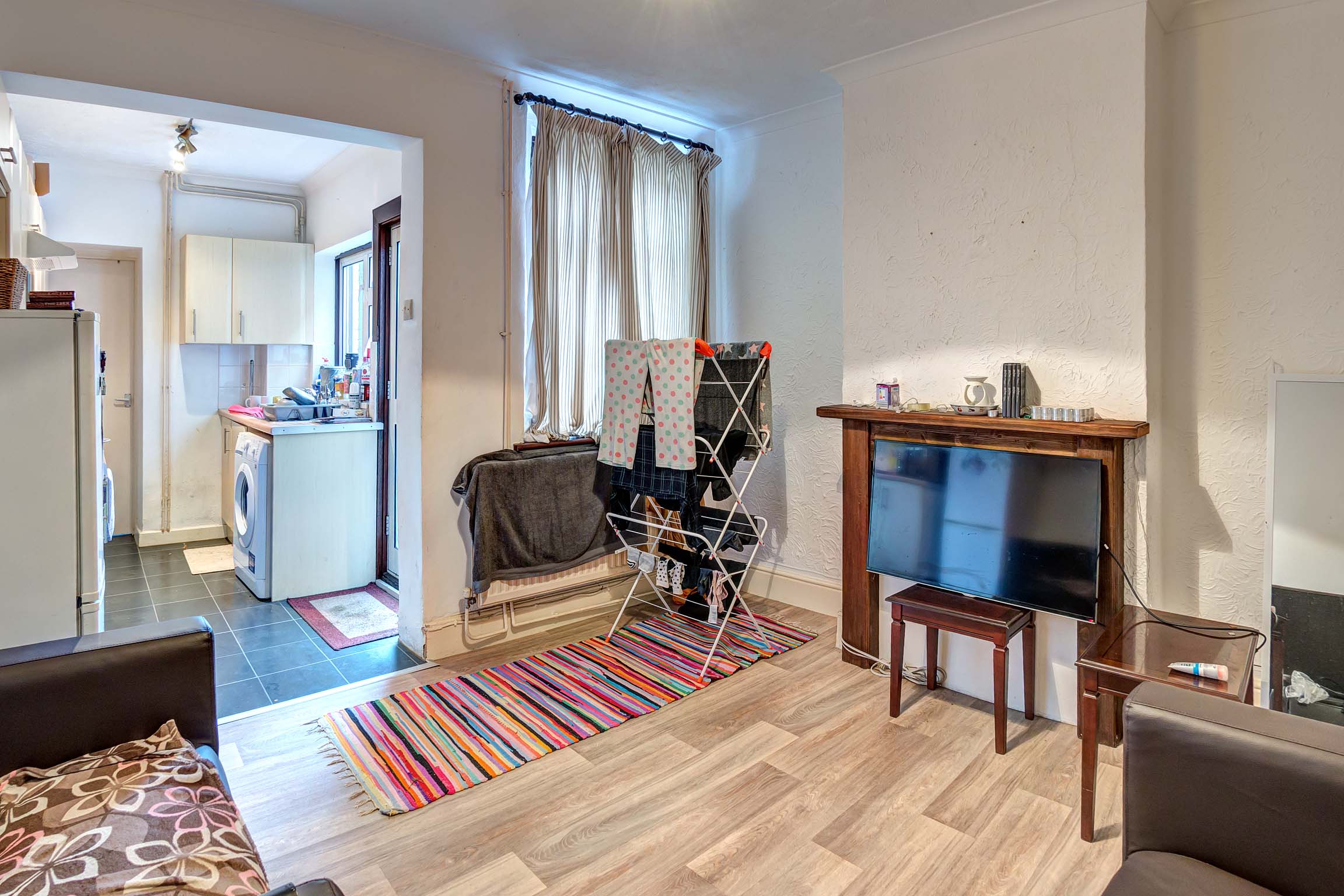 Lounge area with wooden mantlepiece and leather sofas
