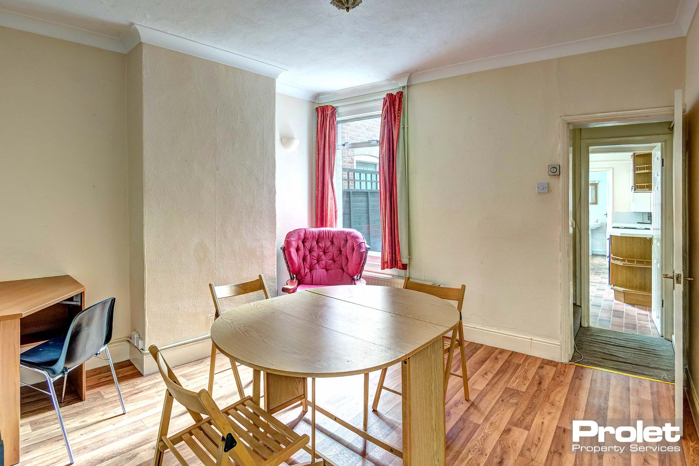 Dining table with wooden flooring and a wooden dining table and wooden chairs.