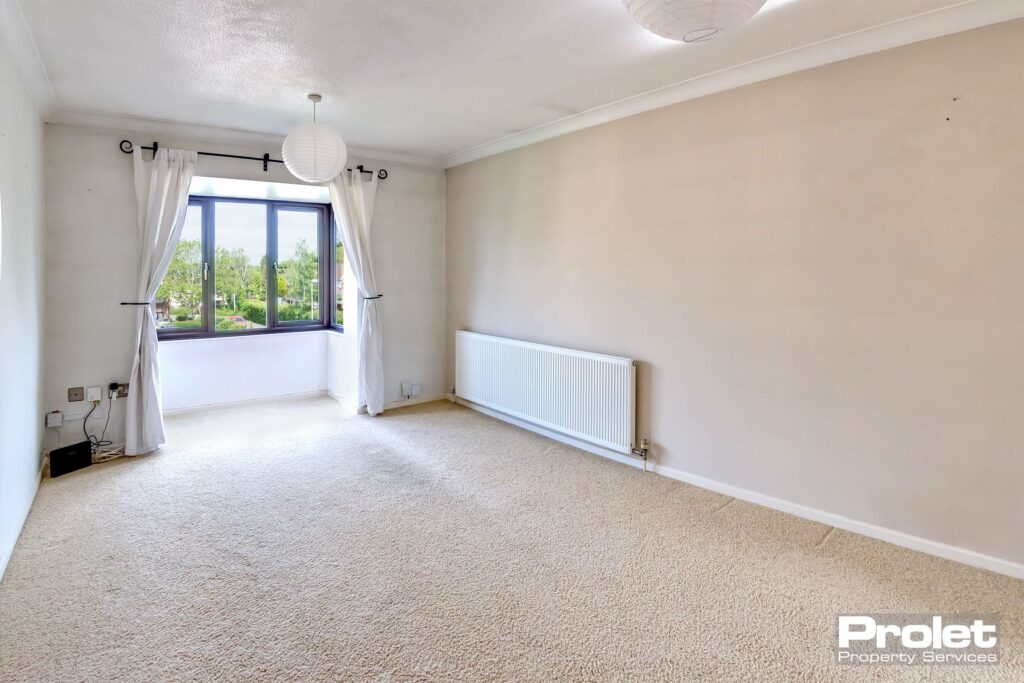 Cream carpet and magnolia walls with bay window