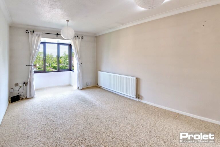Cream carpet and magnolia walls with bay window