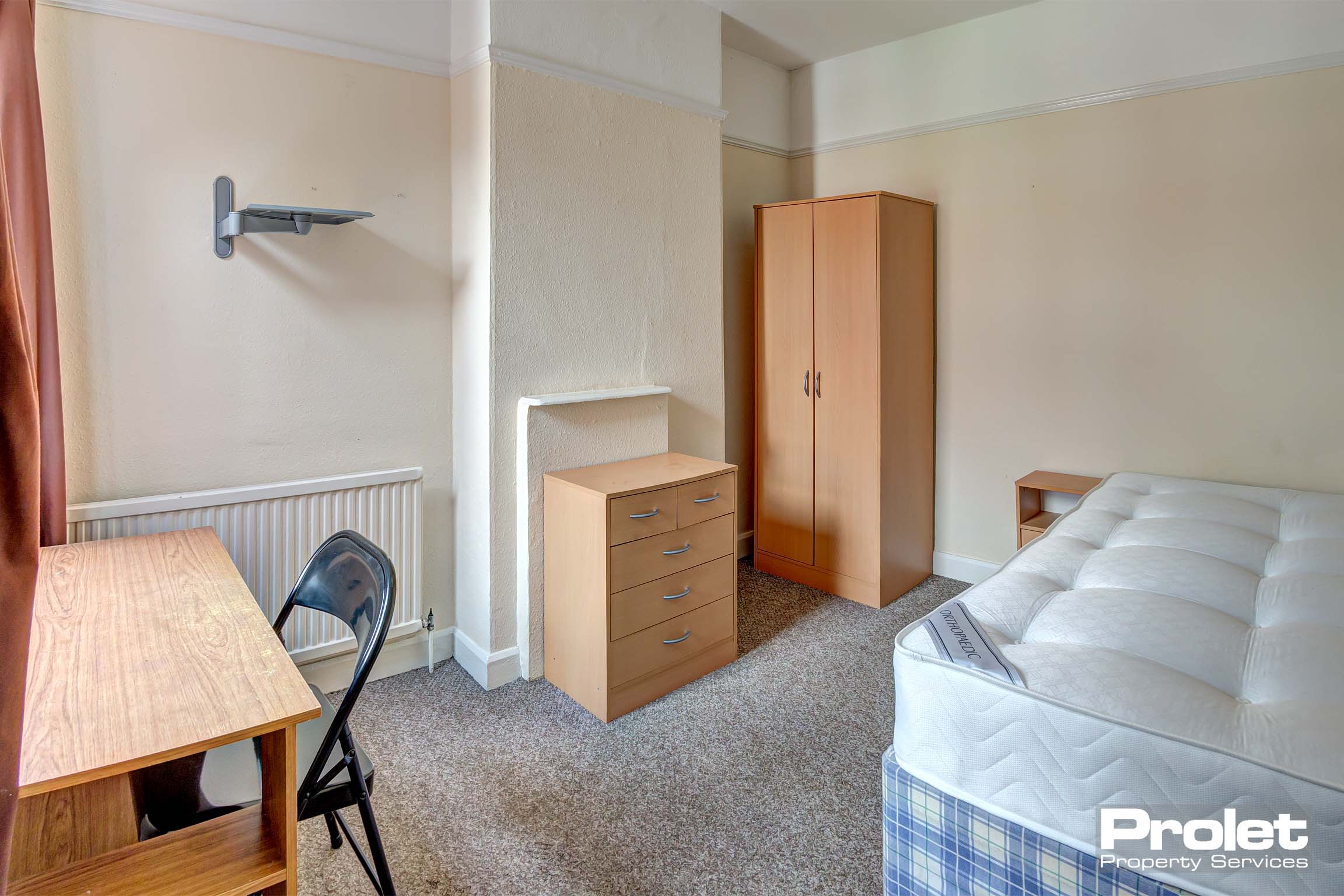 Bedroom with double bed and wooden furnishing