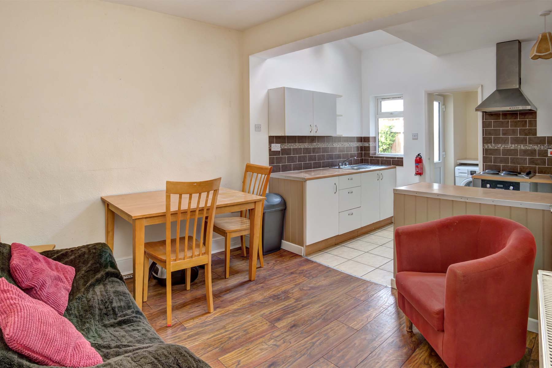 Open planned kitchen with dining and living area, dining set and sofas