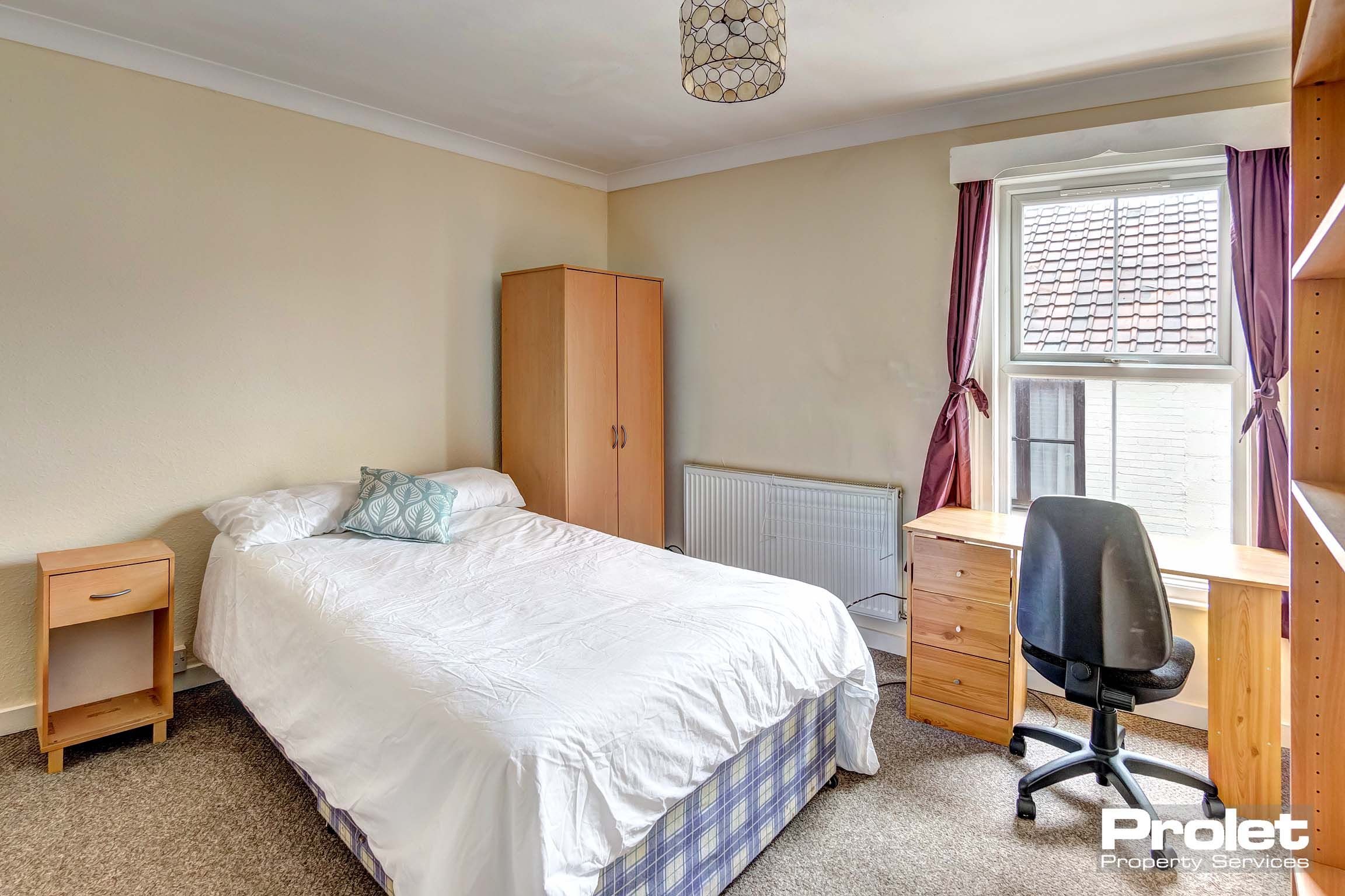 Bedroom with double bed and wooden furnishings