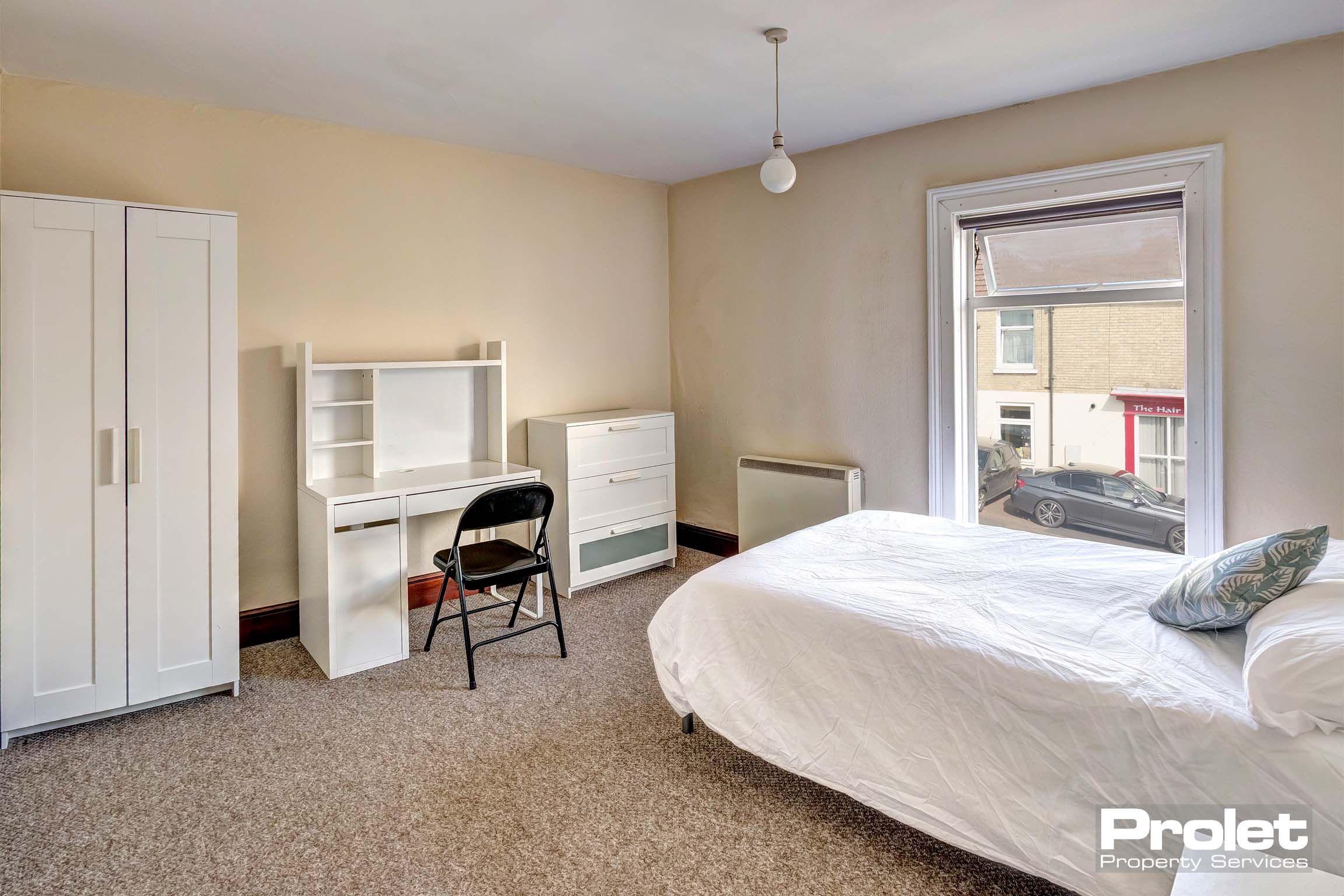 Large bedroom with double bed, and white furnishings