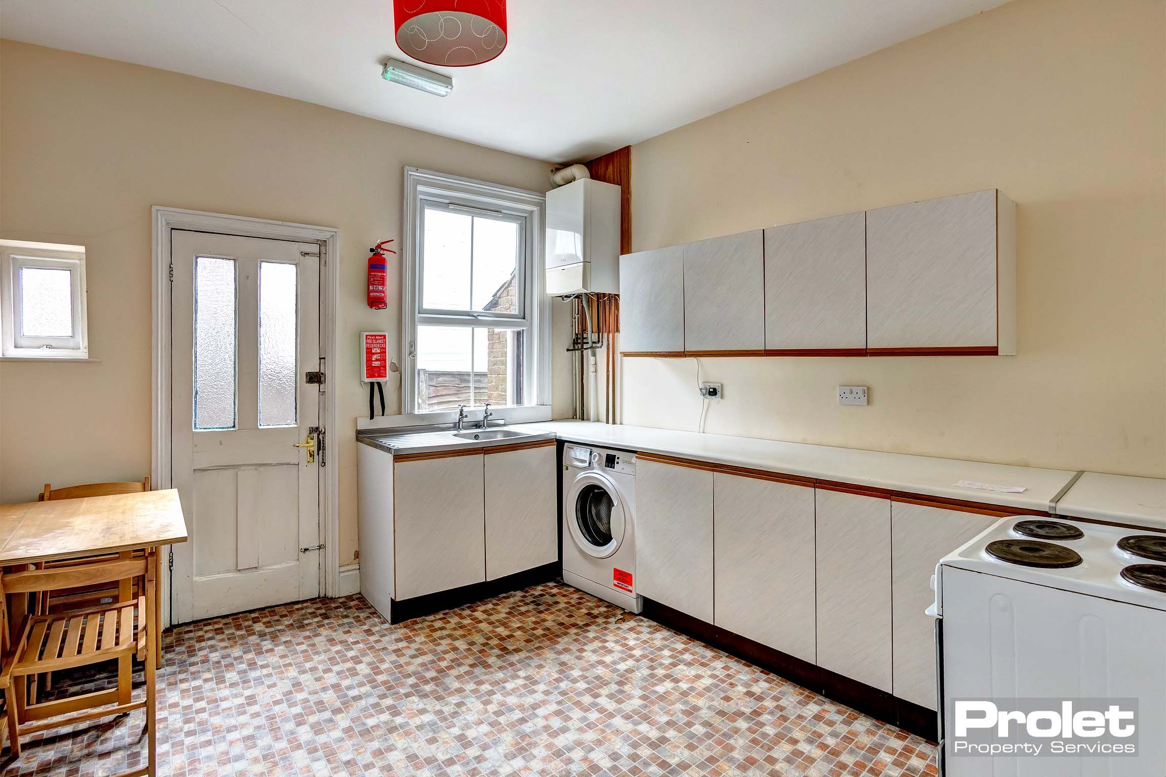 Kitchen with white cabinets and white goods