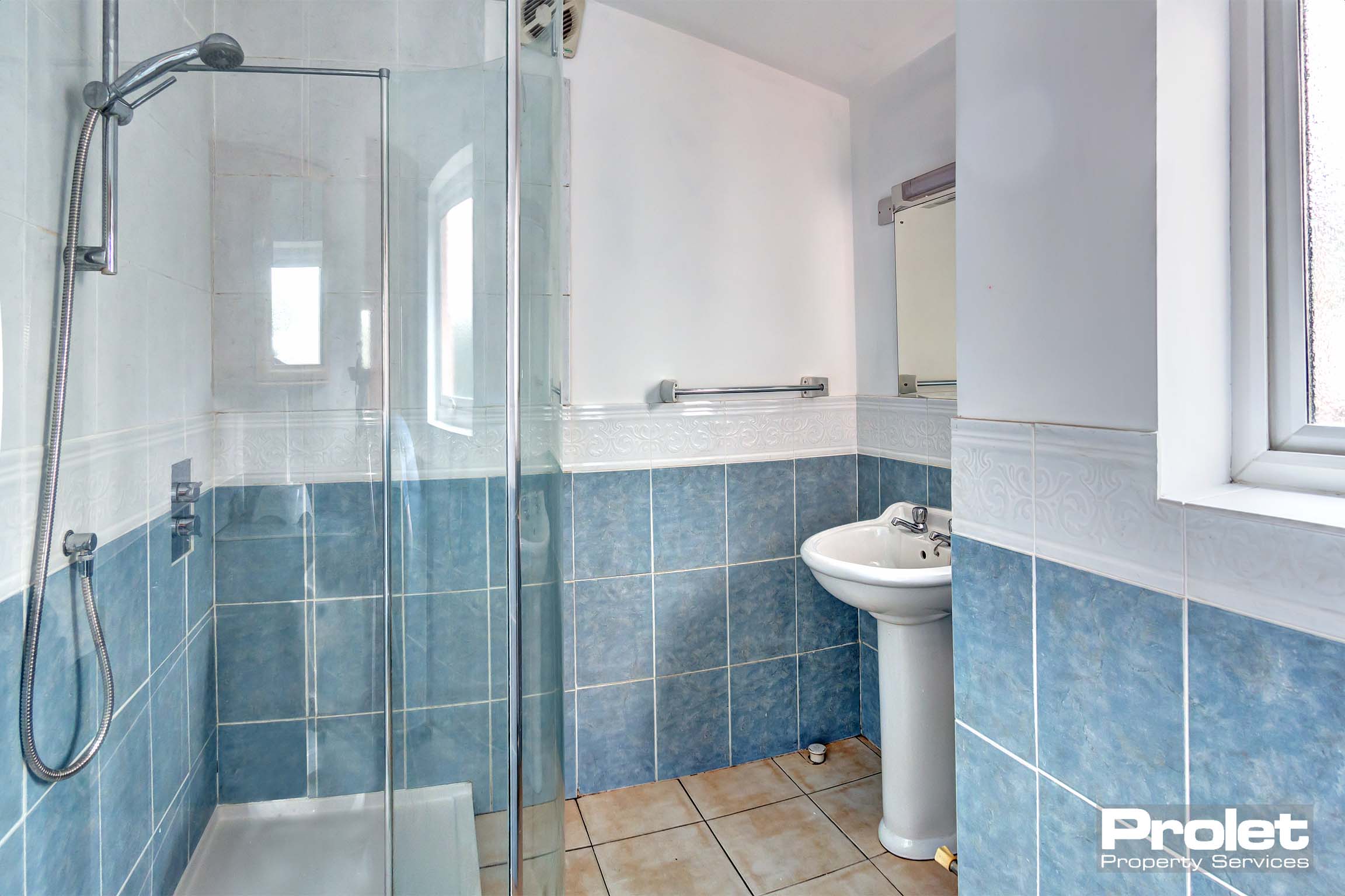 Bathroom with shower cubicle, sink, and toilet