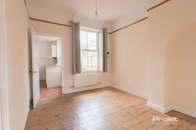 Dining room with hardwood floors leading to kitchen