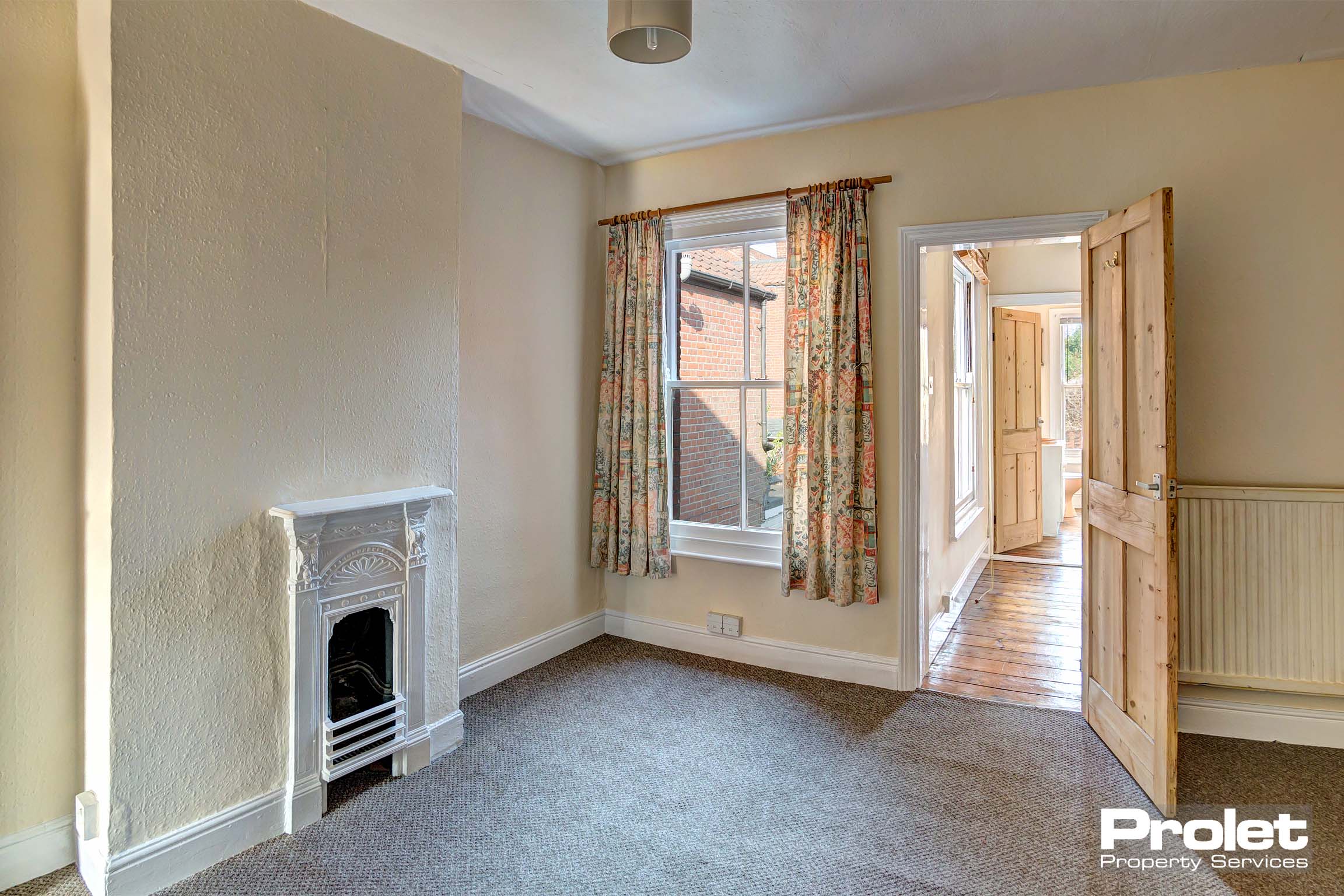 Bedroom with period fireplace leading to en-suite