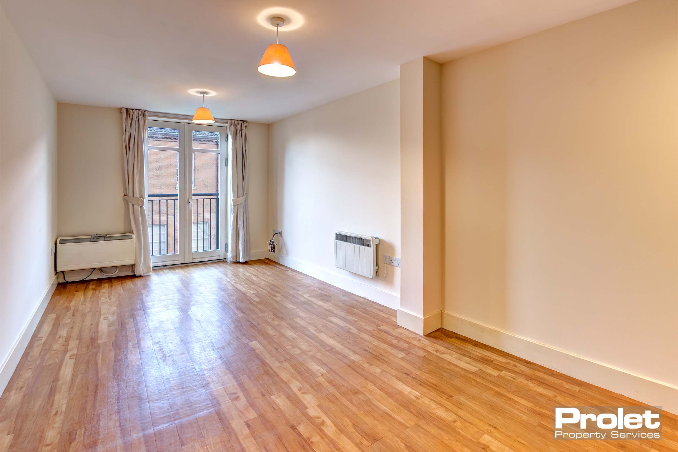 Magnolia walls and laminate flooring with Juliette balcony