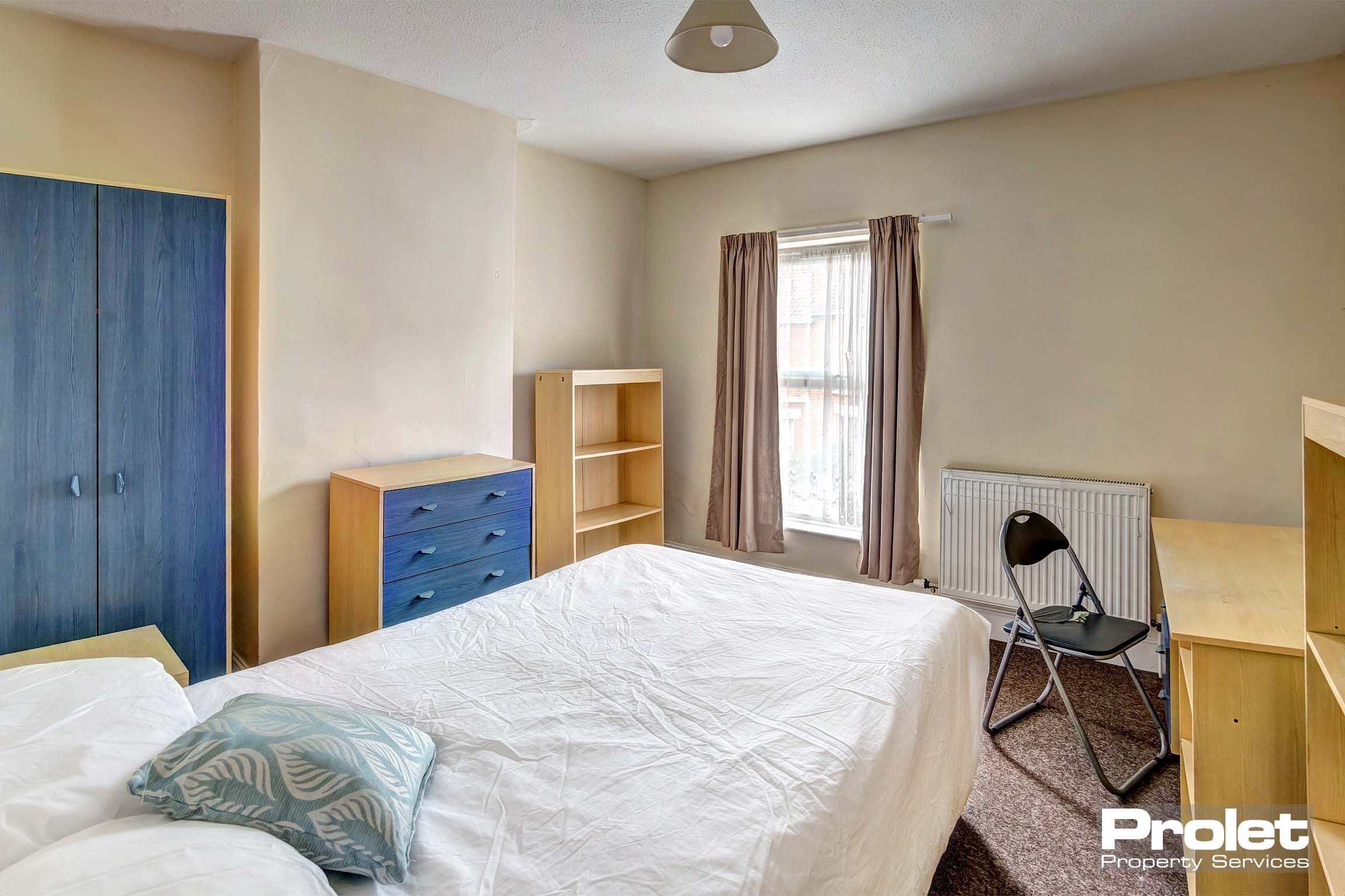 Bedroom with double bed and wooden furnishings