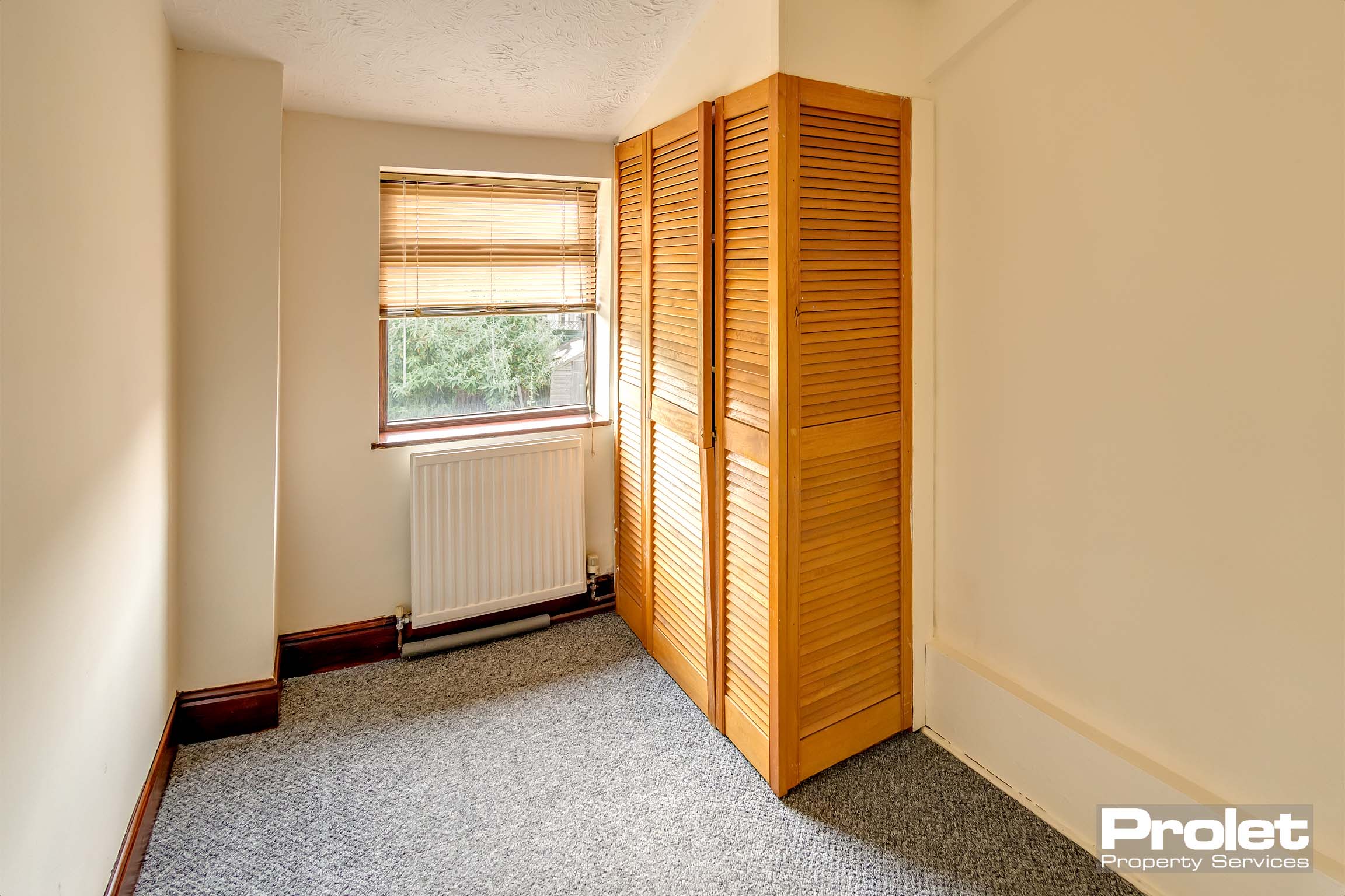 Grey carpets and magnolia walls
