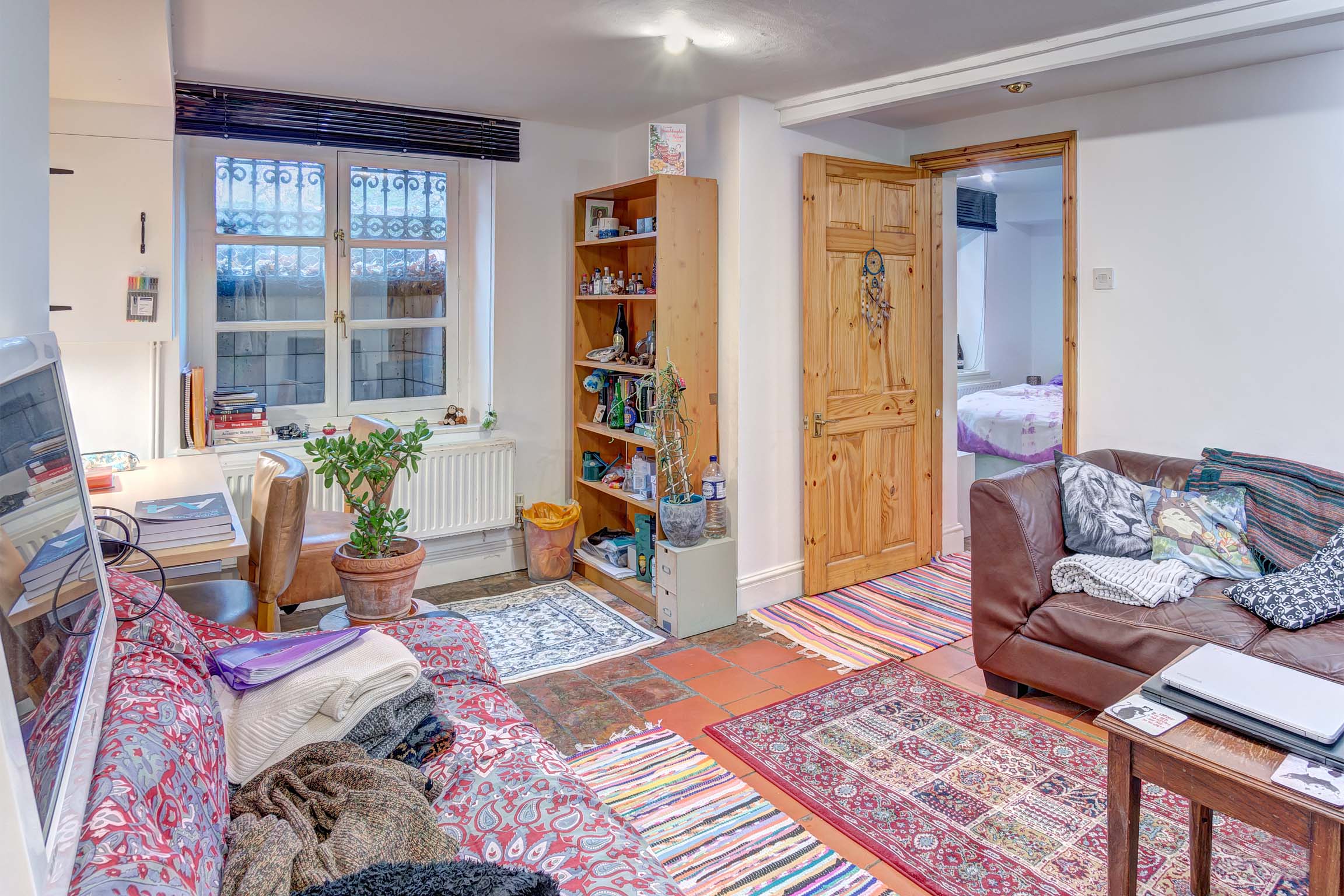 Living area with sofas, dining area, and bookcase.