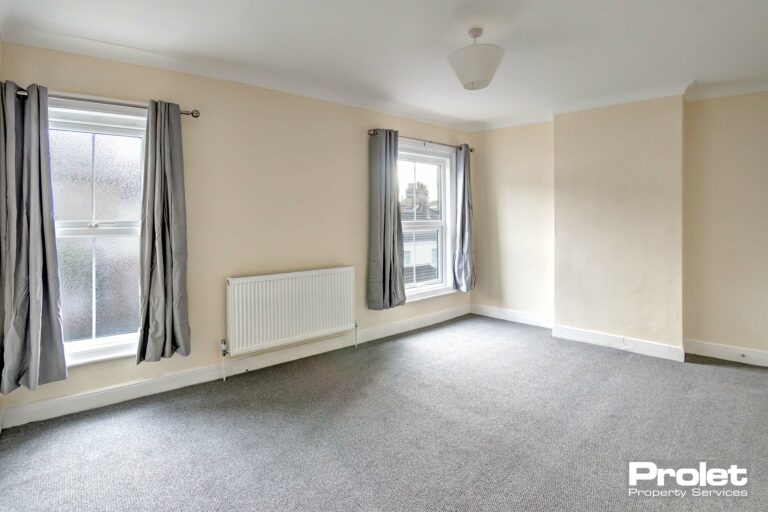Large double bedroom with new grey carpets, and cream walls
