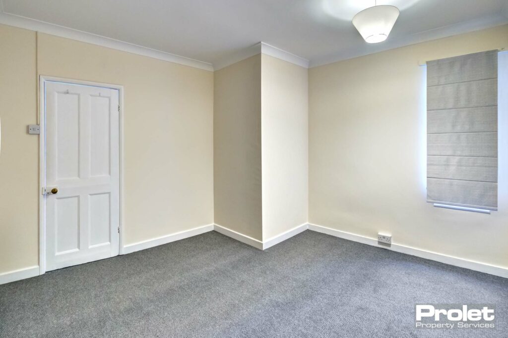 Double bedroom with new grey carpets, and cream walls