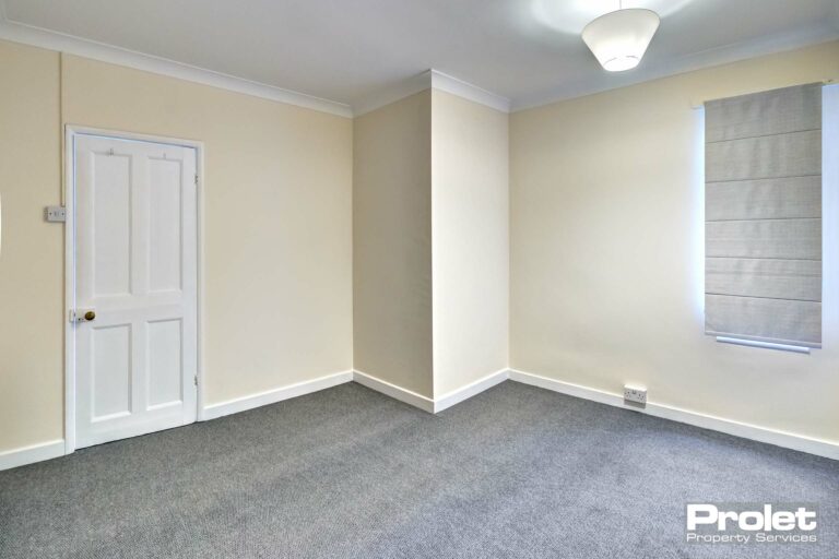 Double bedroom with new grey carpets, and cream walls