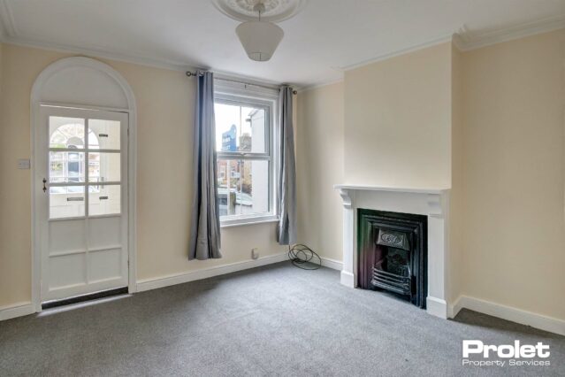 Living room with grey carpets, and period fireplace
