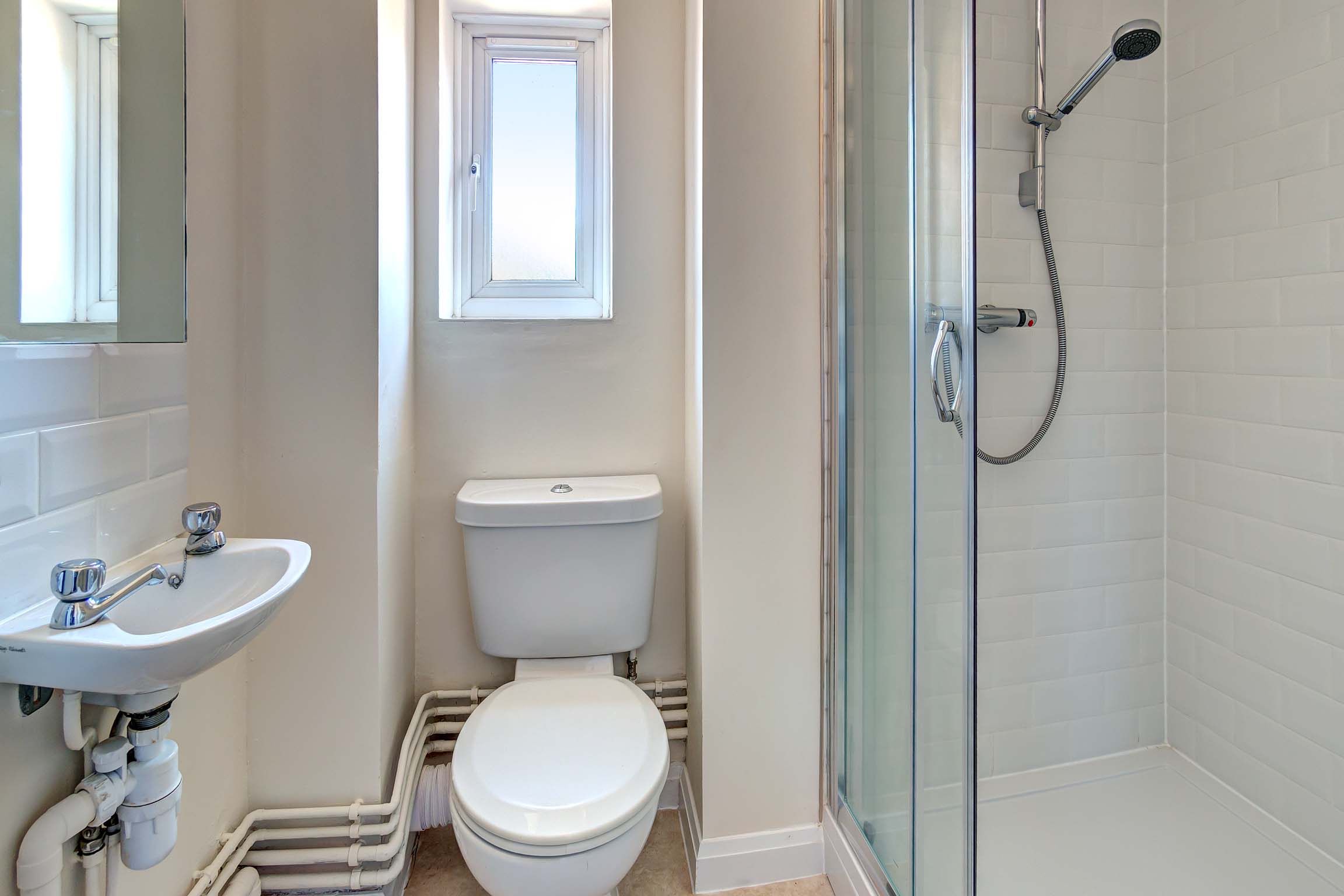 Bathroom with shower cubicle, sink, and toilet