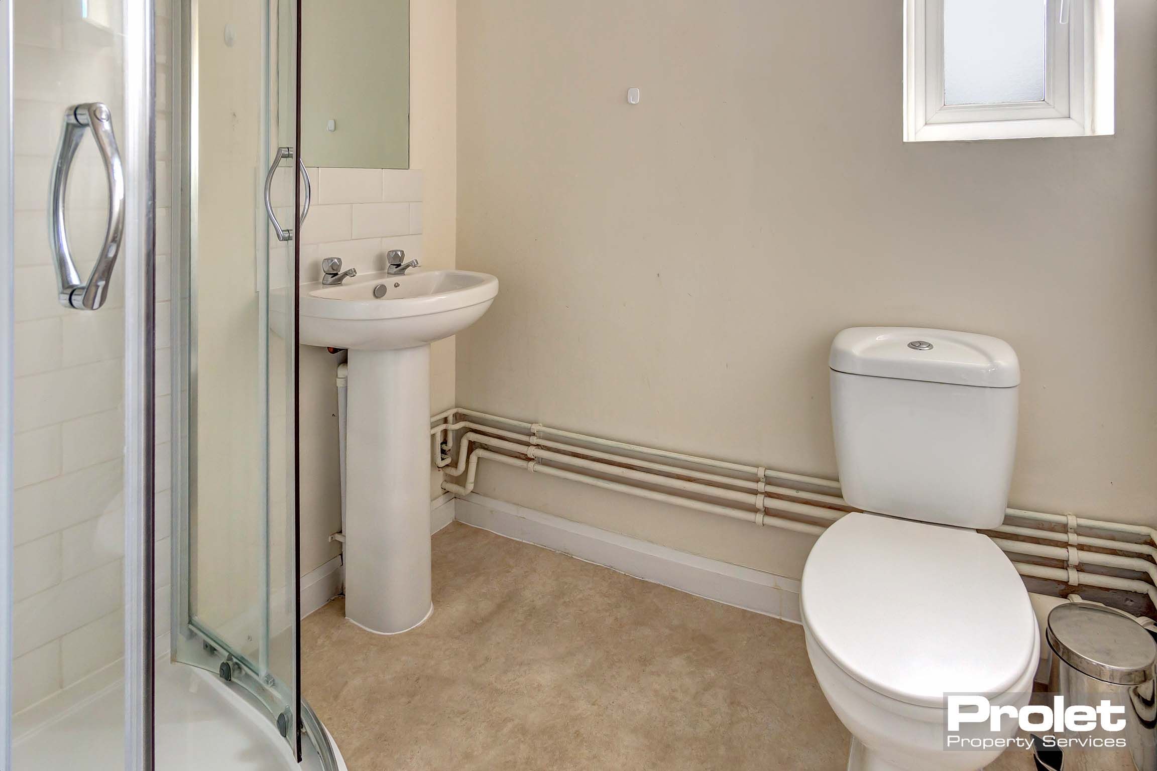 Bathroom with shower cubicle, sink, and toilet