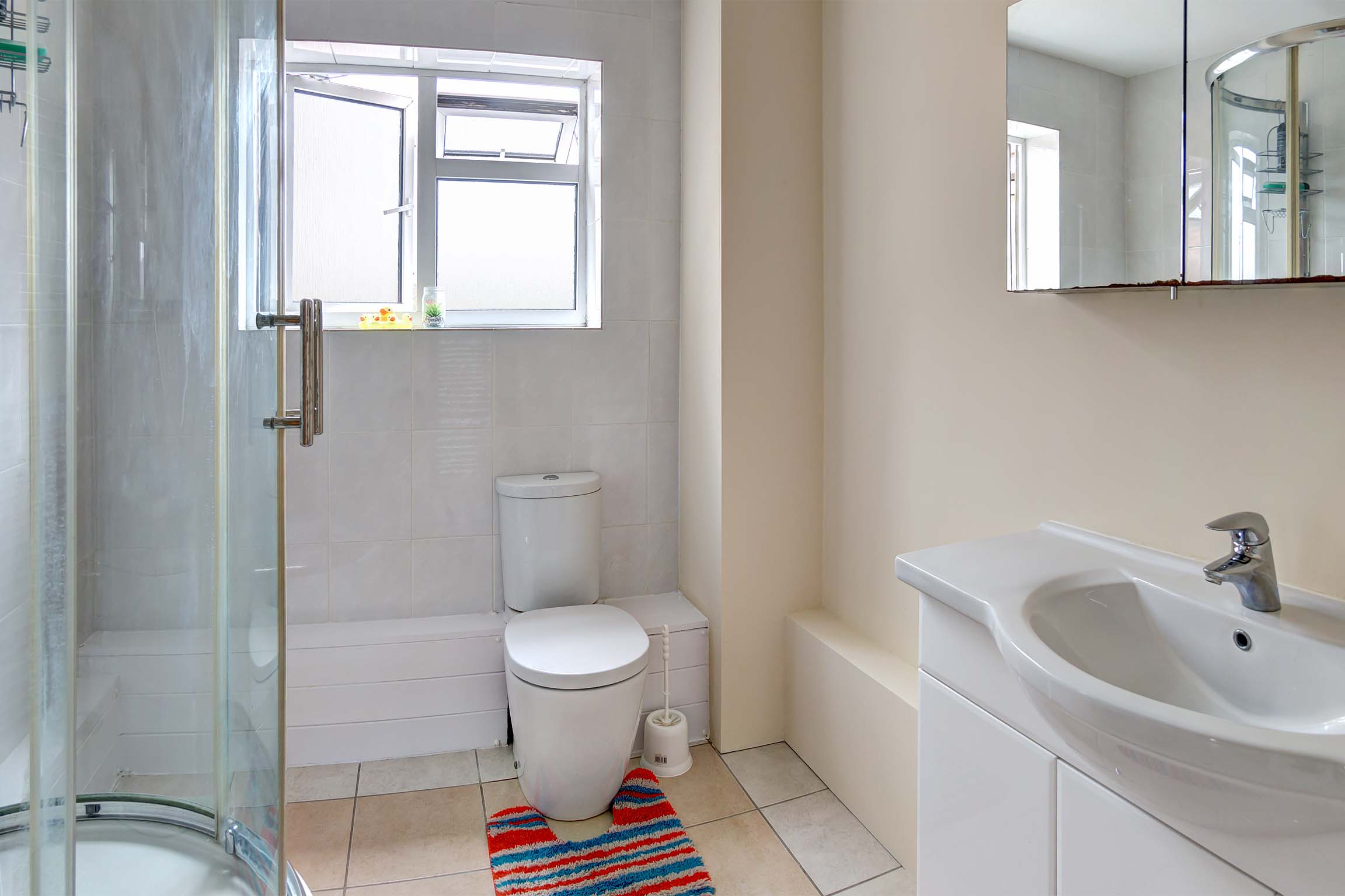 Bathroom with shower cubicle, toilet and sink