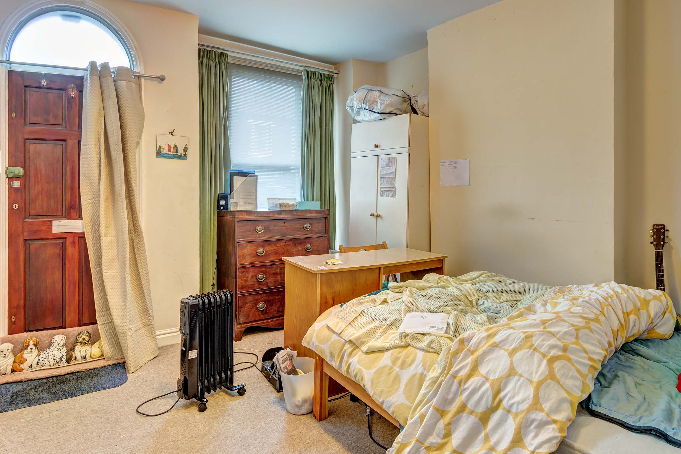 Bedroom with double bed, box bay window, and wooden furnishings