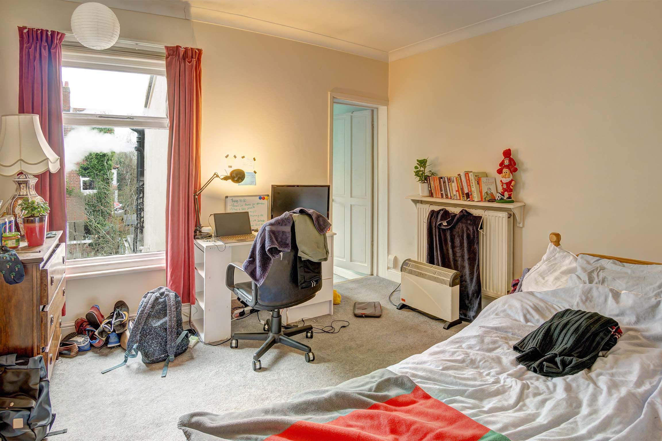 Bedroom with double bed, desk, and en-suite bathroom