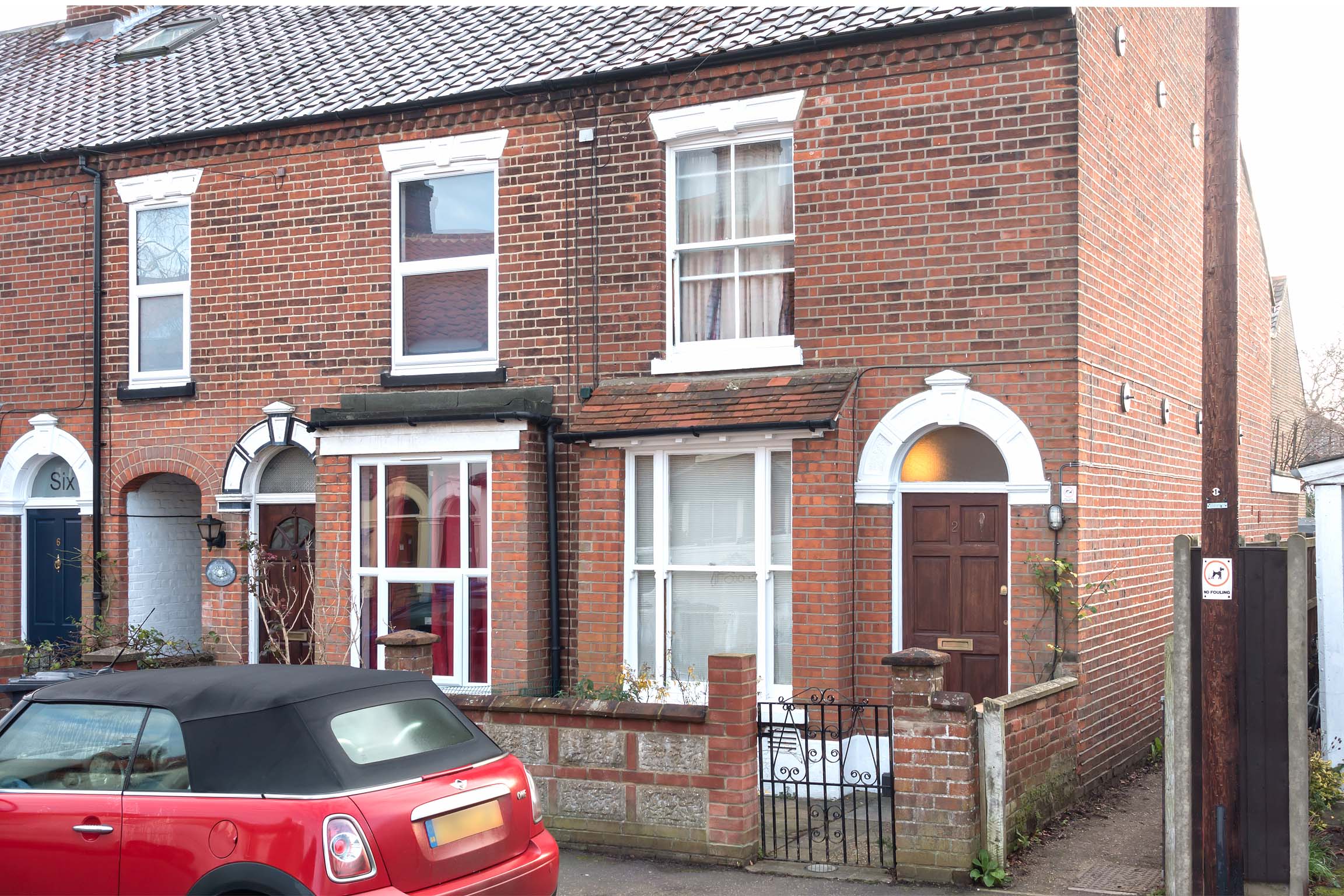 Red brick terraced house with wooden front door