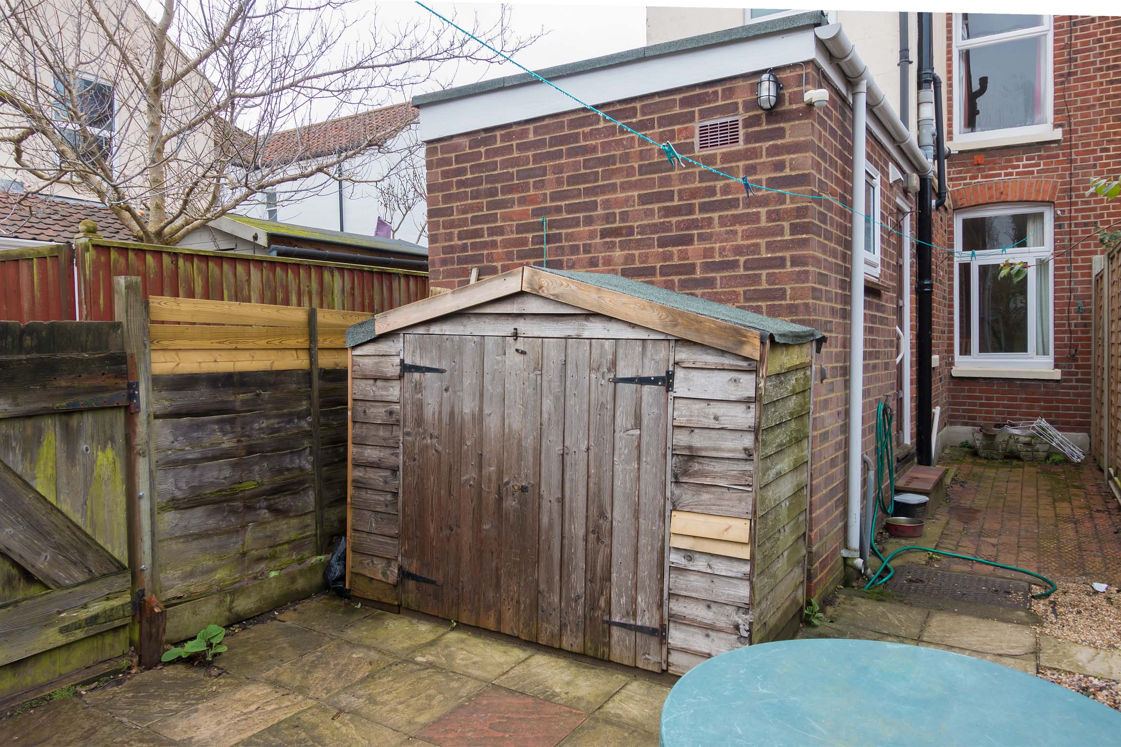 Paved garden with bike shed