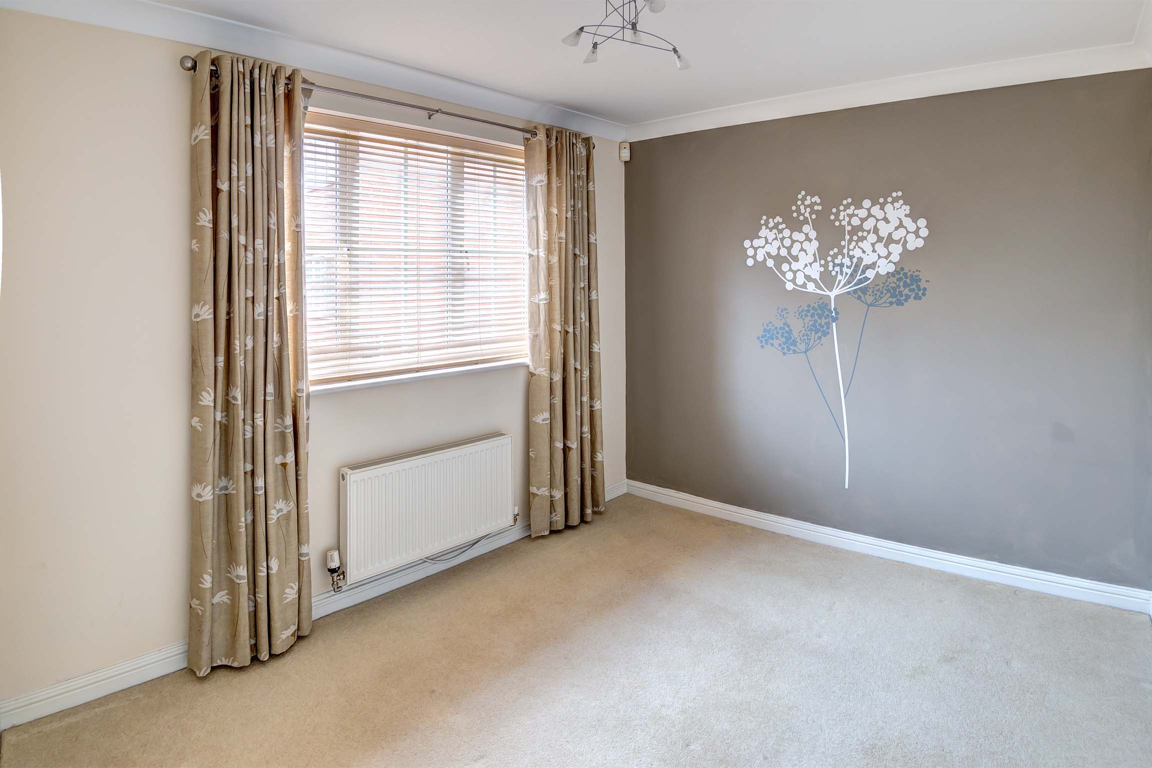 Dining area with patterned wallpaper and curtains