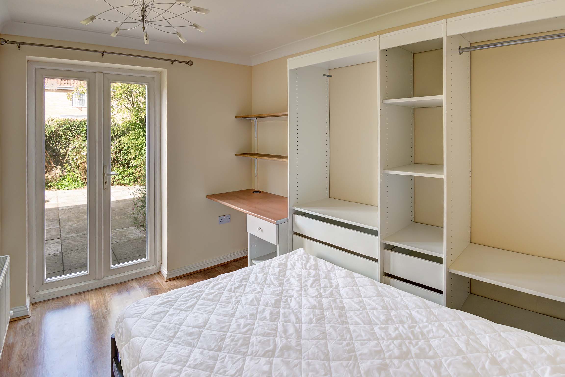 Bedroom with built in storage and french doors