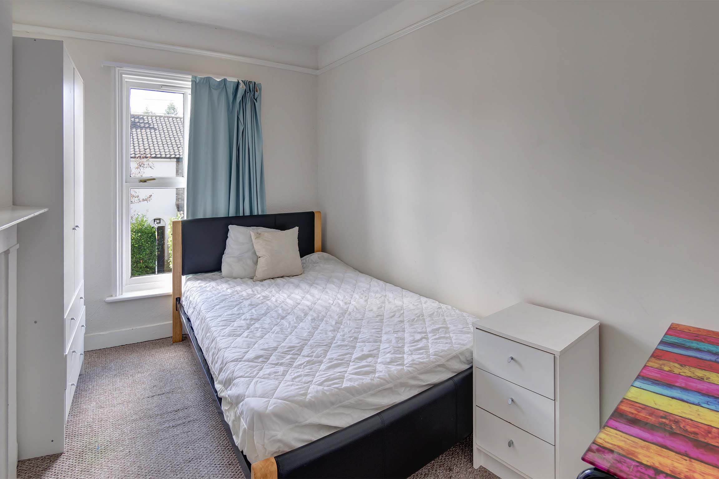 Bedroom with double bed and white furnishings