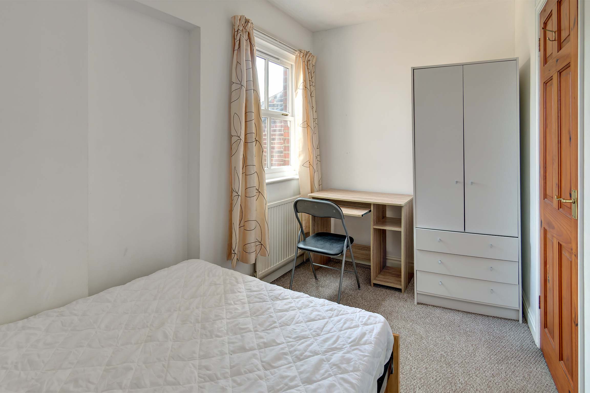 Bedroom with double bed and white furnishings