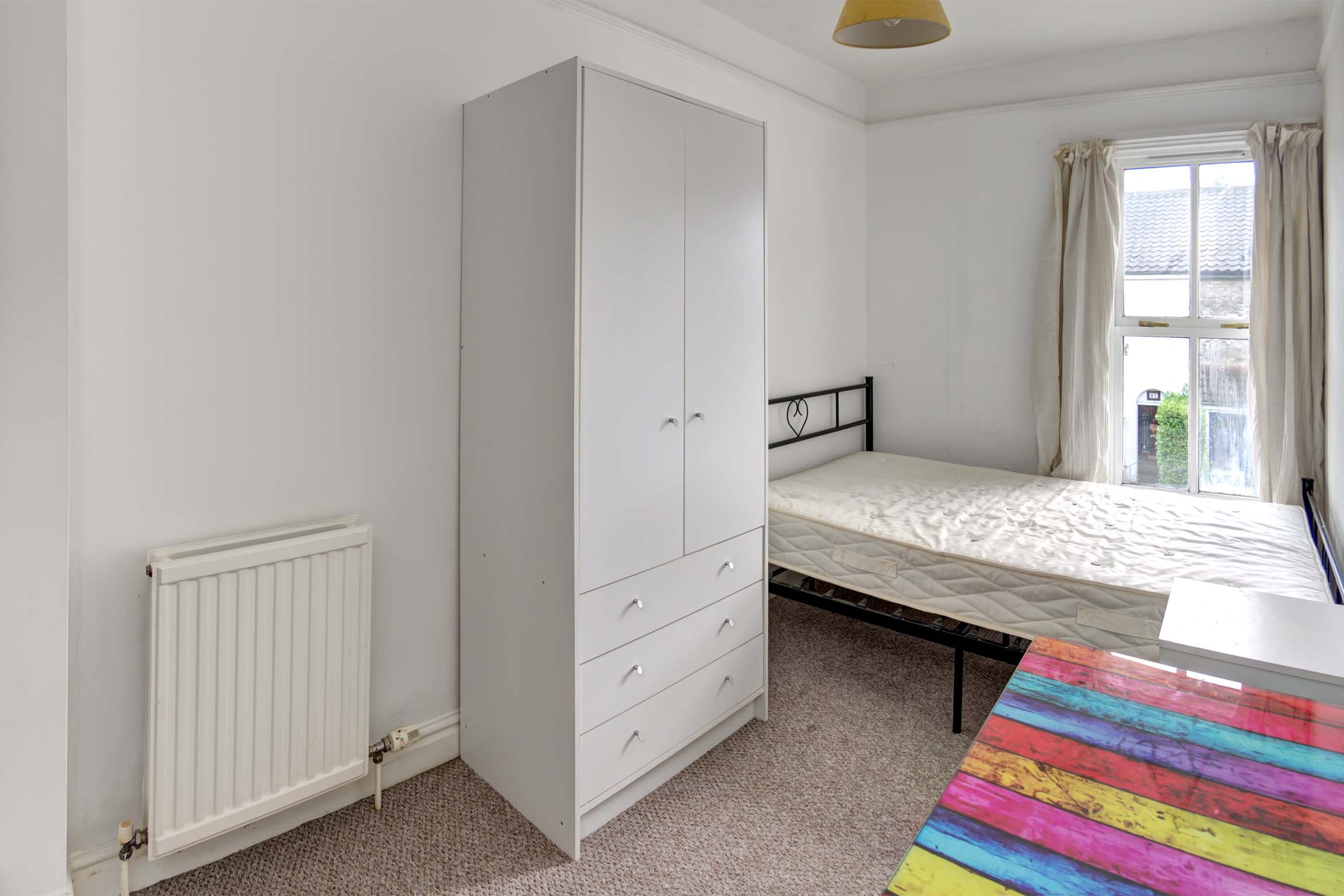 Bedroom with double bed and white furnishings