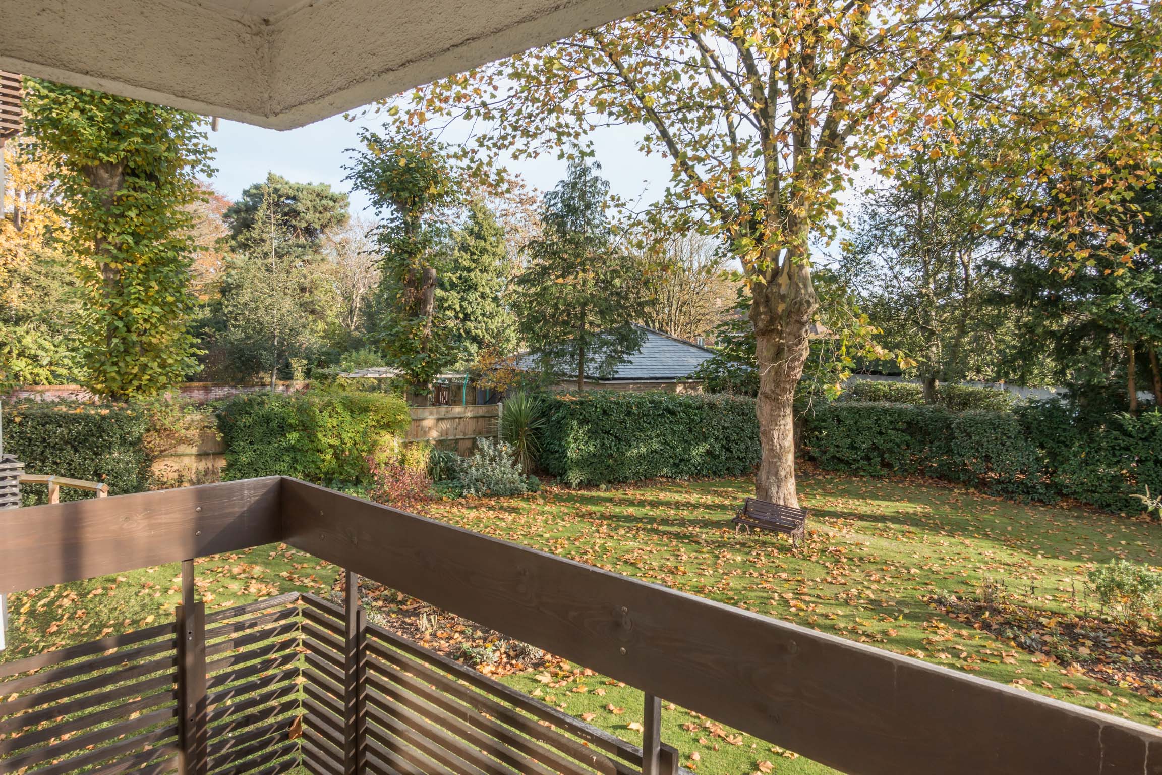 Balcony over look green communal garden and trees