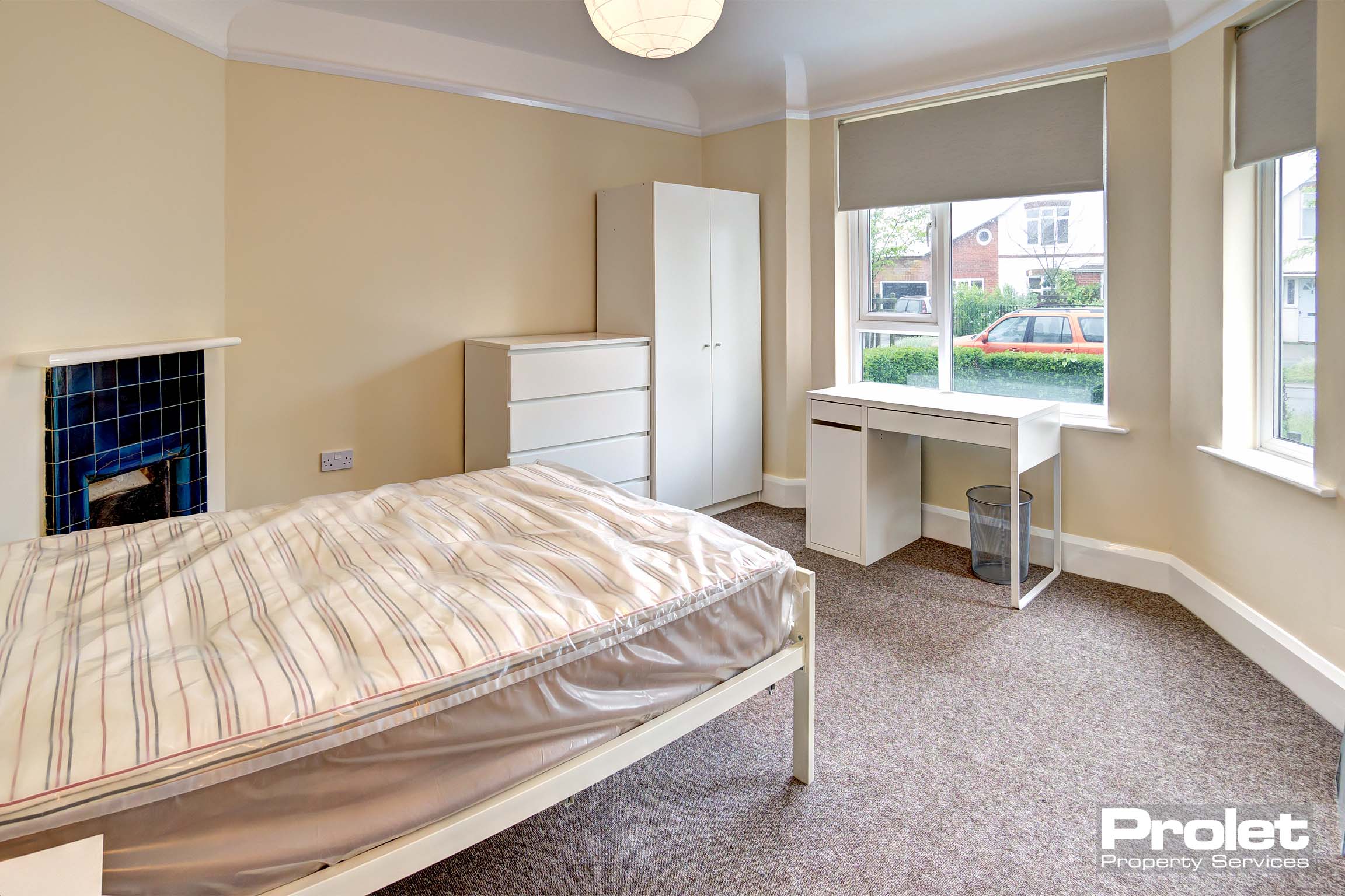 Bedroom with double bed and white furnishings