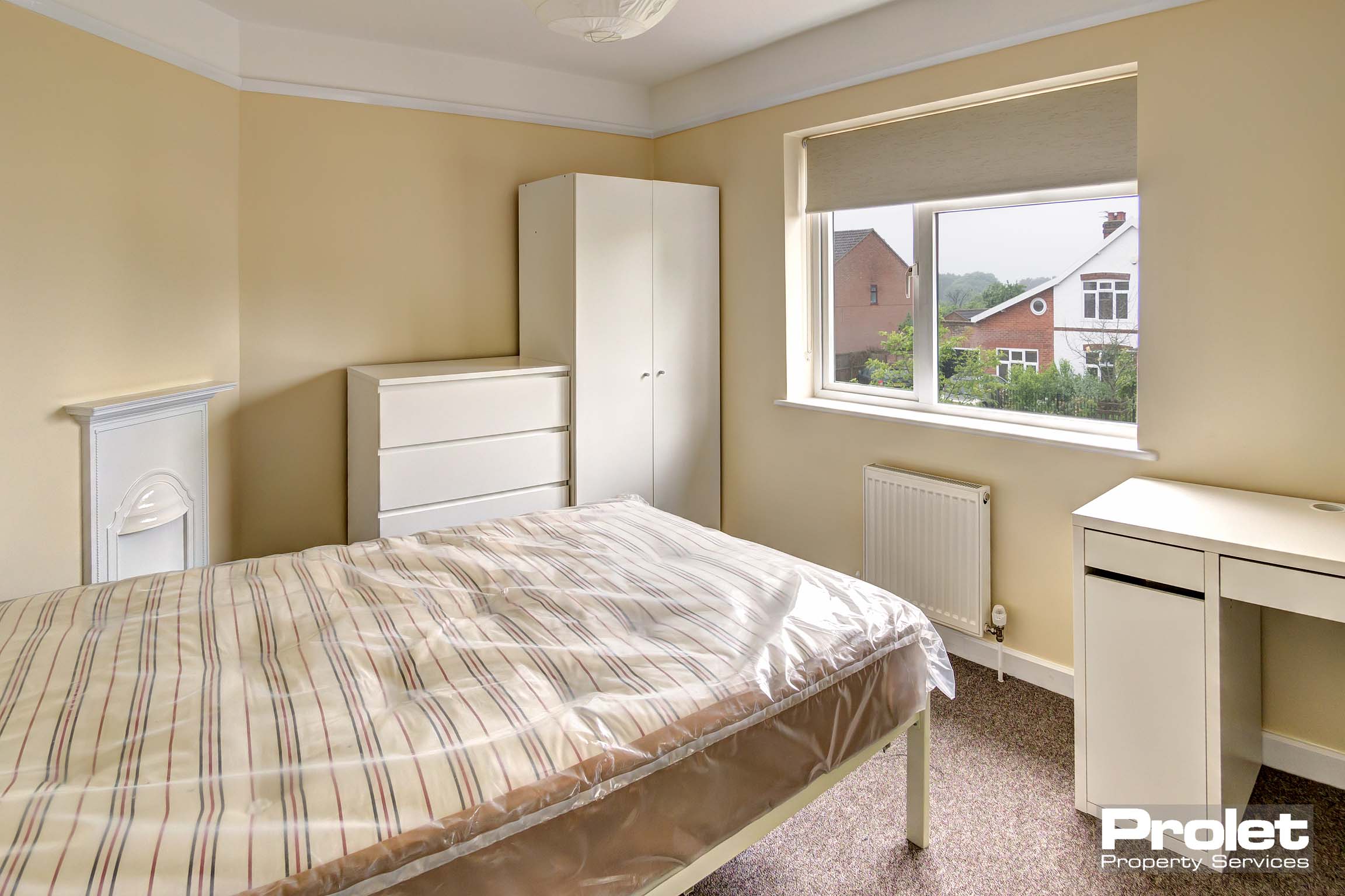 Bedroom with double bed and white furnishings