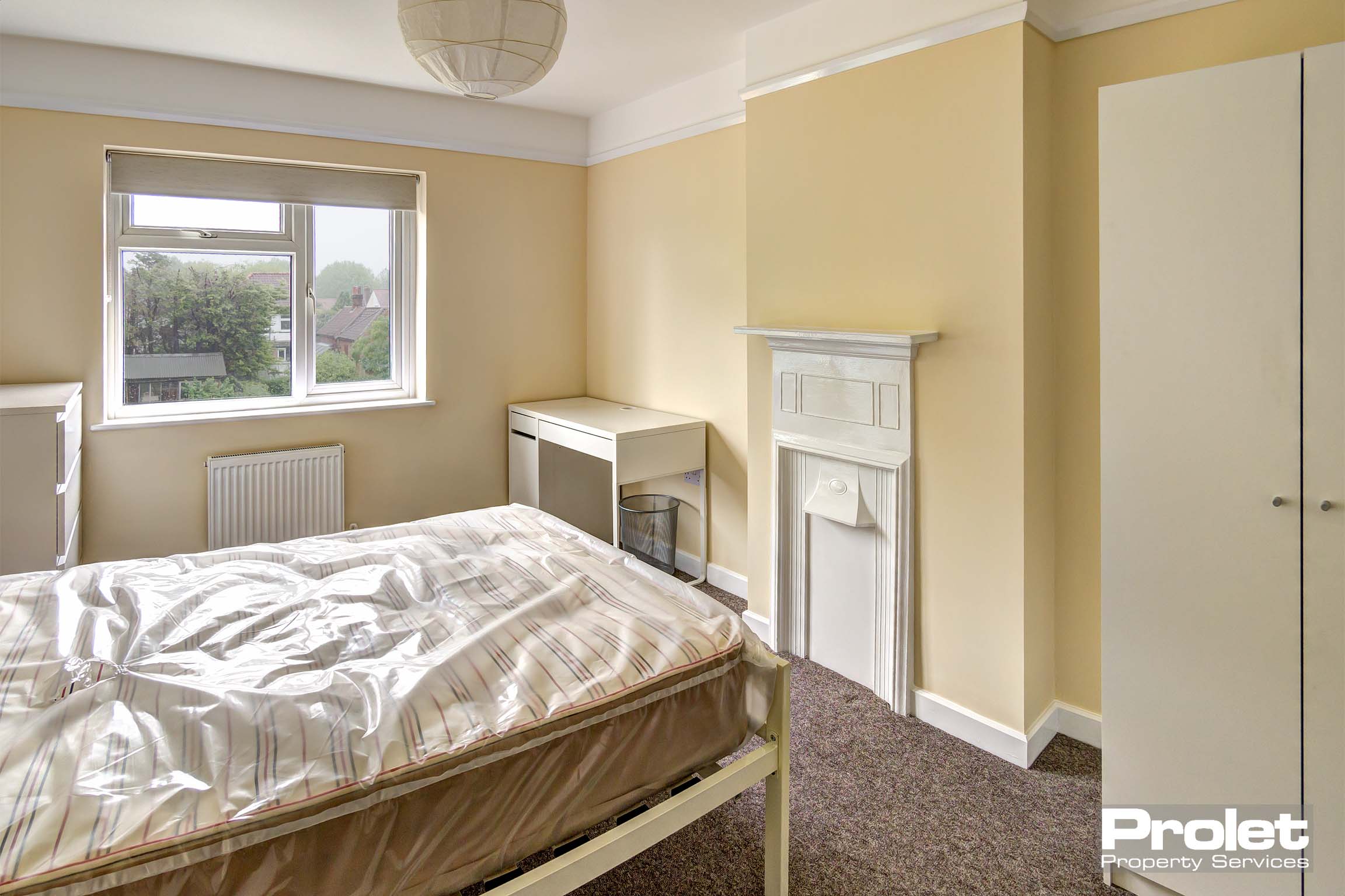 Bedroom with double bed and white furnishings