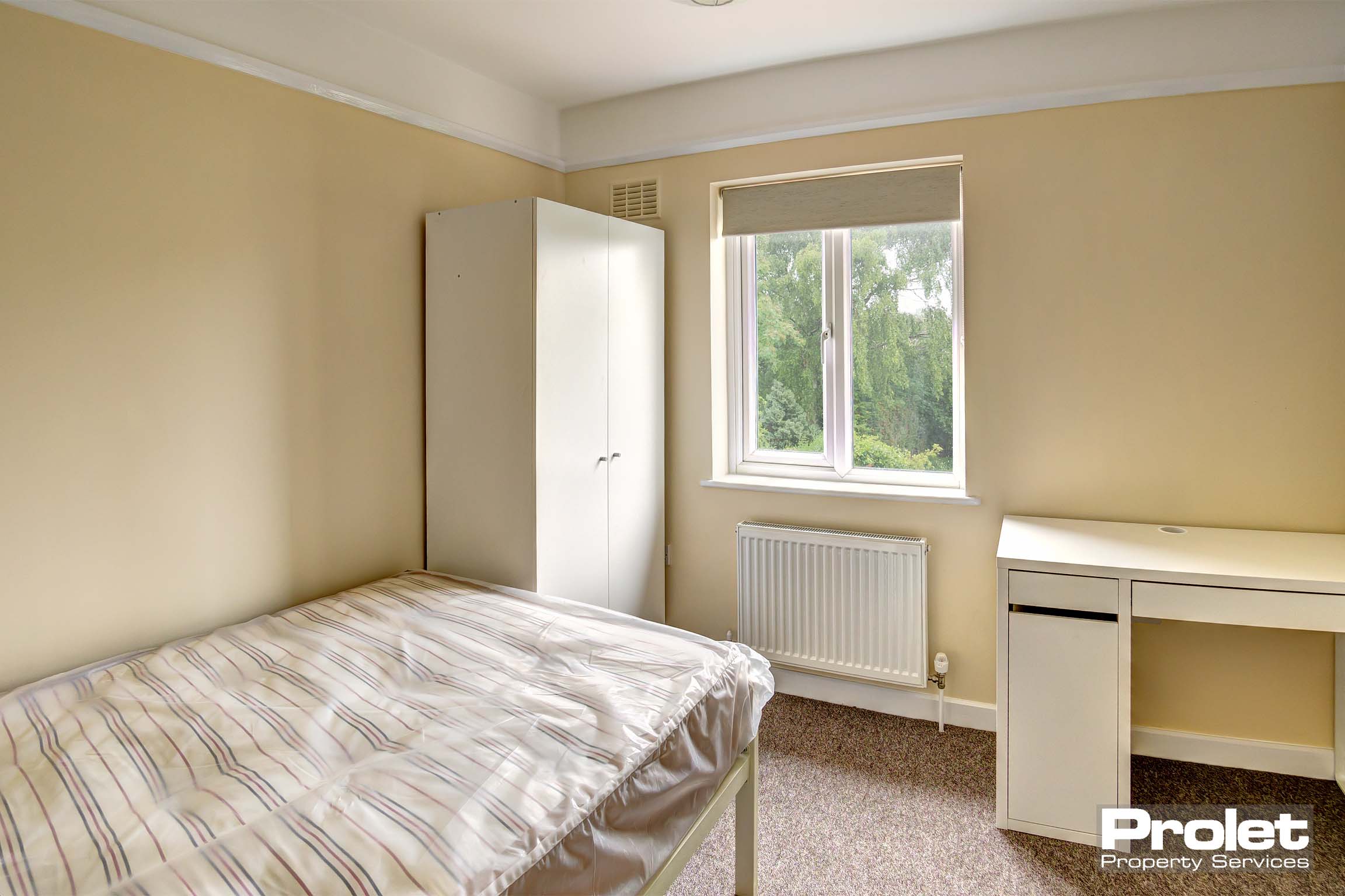 Bedroom with double bed and white furnishings
