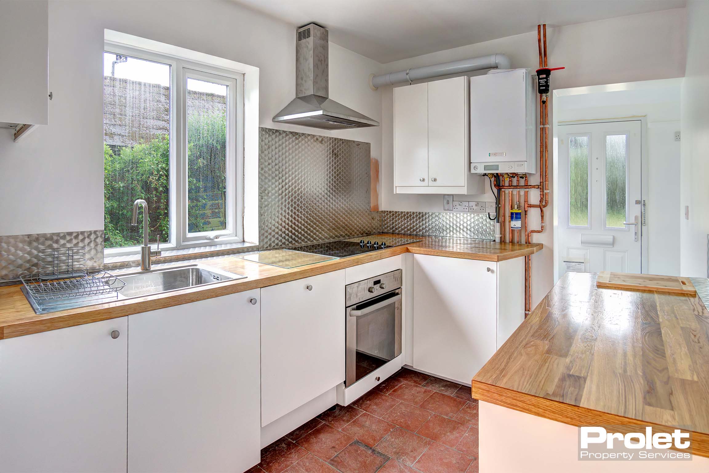 Modern kitchen with white cabinets and wood effect worktops