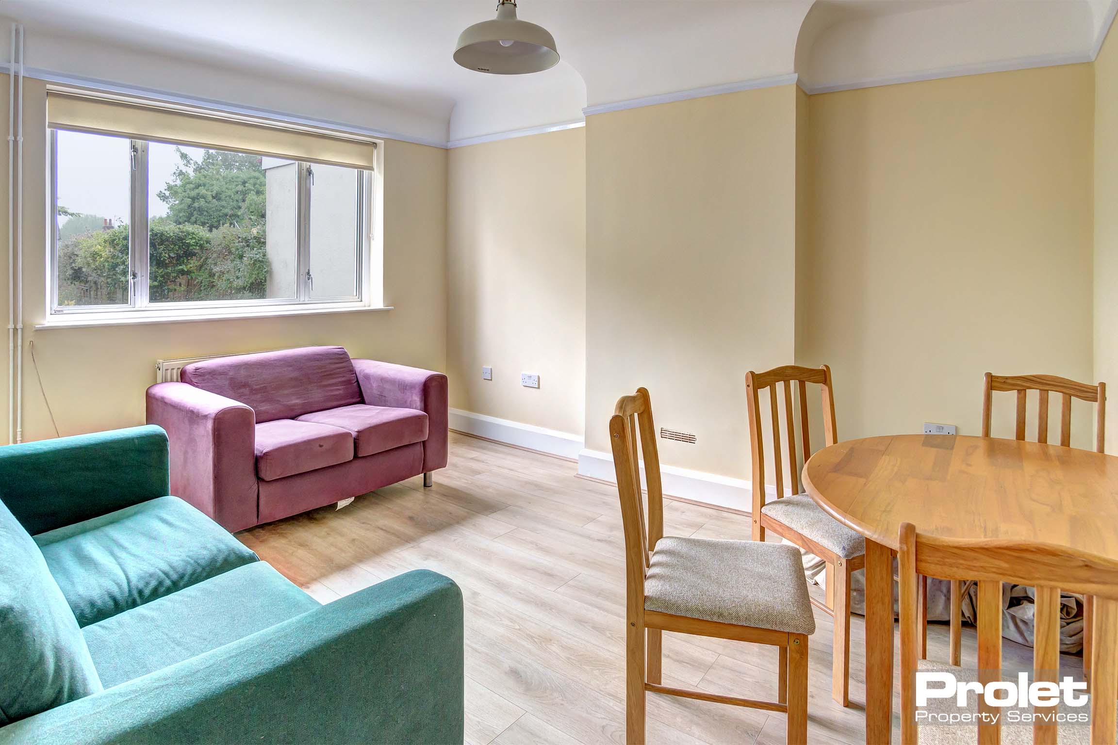Living/dining room with laminate flooring, sofa's and dining set