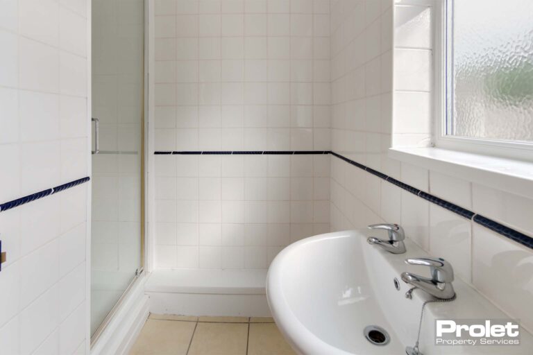 Tiled shower room with sink