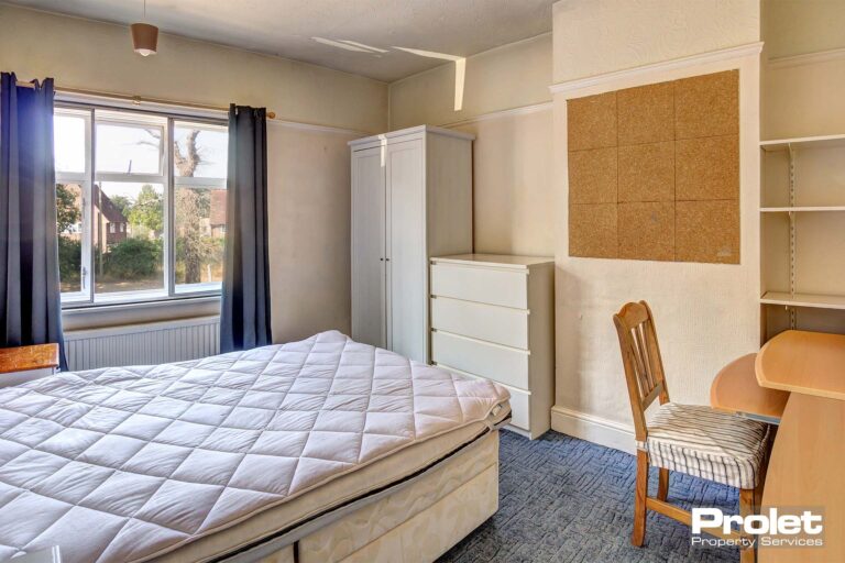 Bedroom with double bed, wardrobe, desk, and chest of drawers