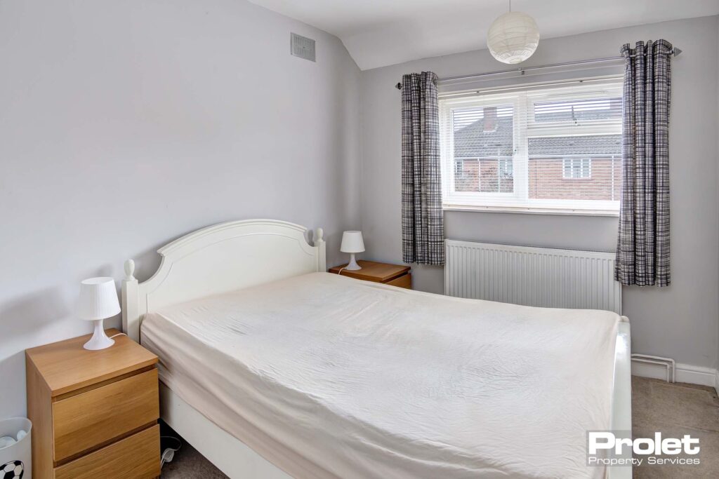 Bedroom with double bed and white walls