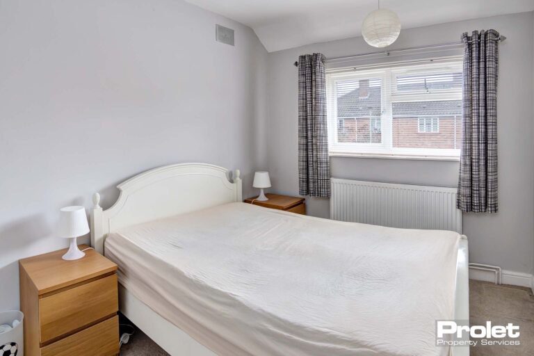 Bedroom with double bed and white walls
