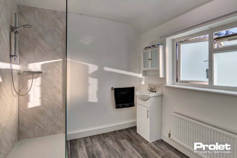 Large shower room with walk in shower and laminate flooring