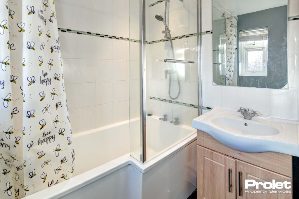 Shower over bath with sink